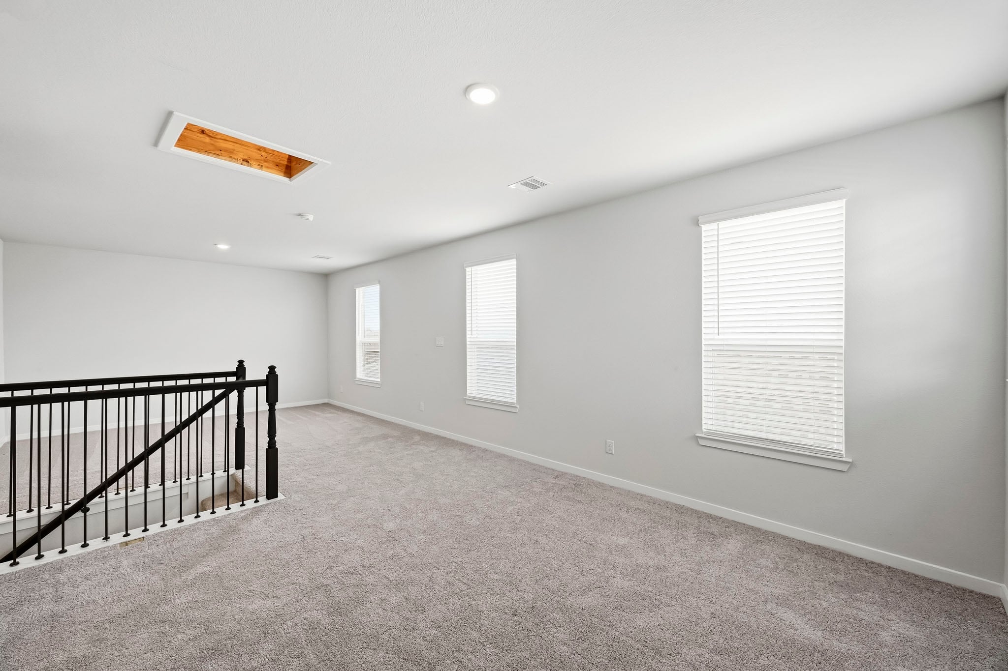 A room with a railing and windows.