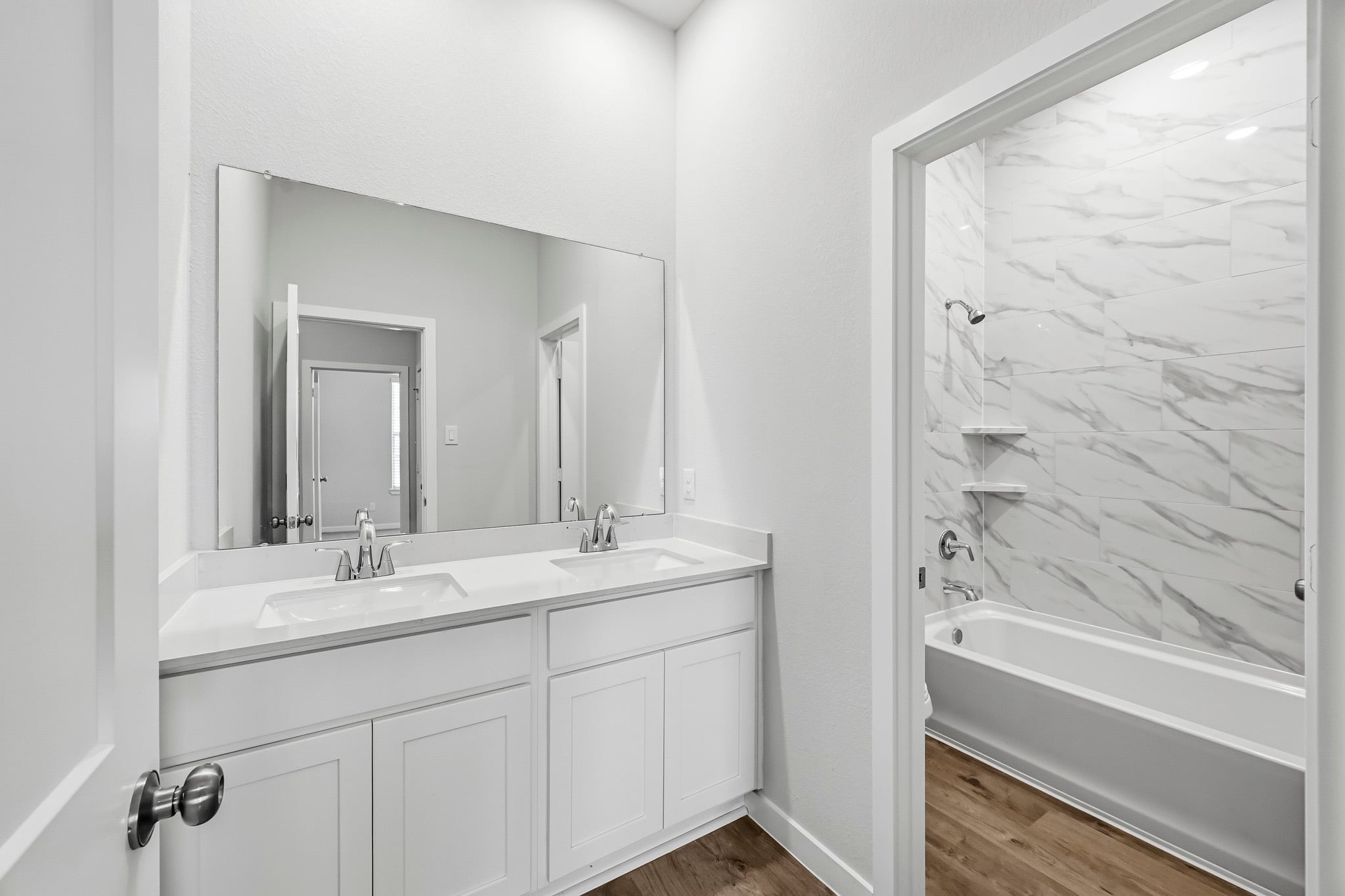 A bathroom with a tub sink and a bathtub.