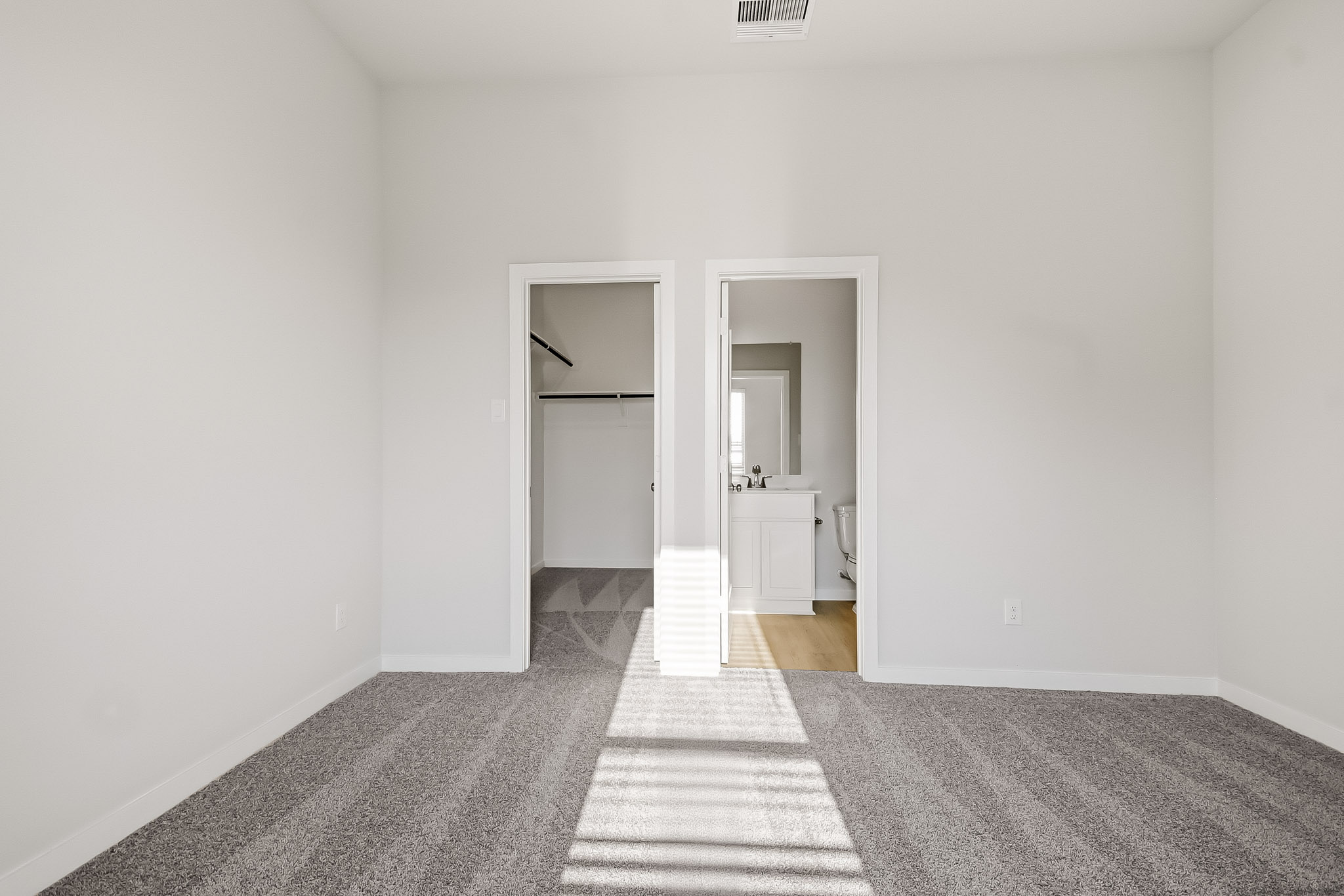 A room with a mirror and a rug.