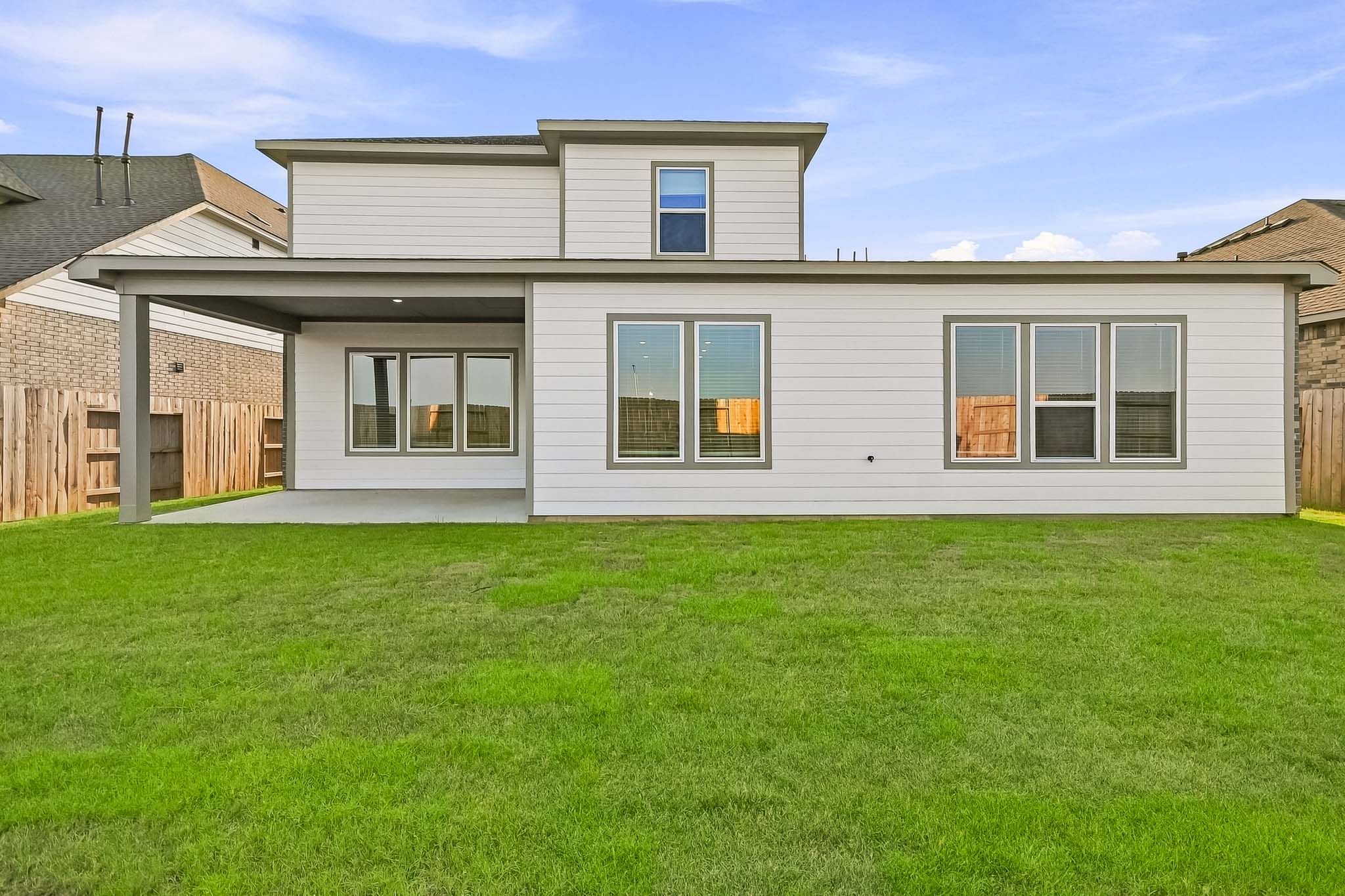 A house with a lawn in front of it.