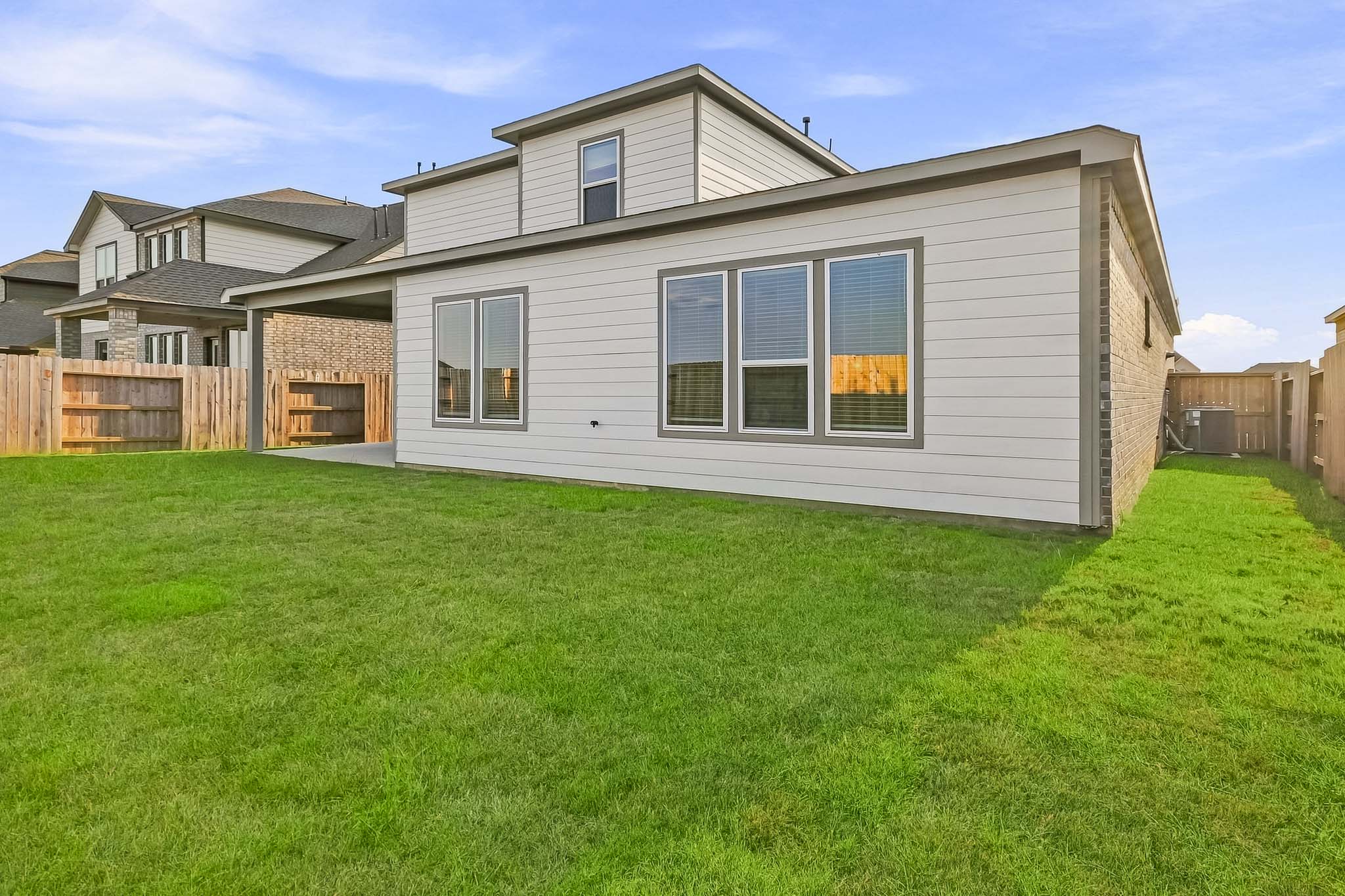 A house with a fence and grass.