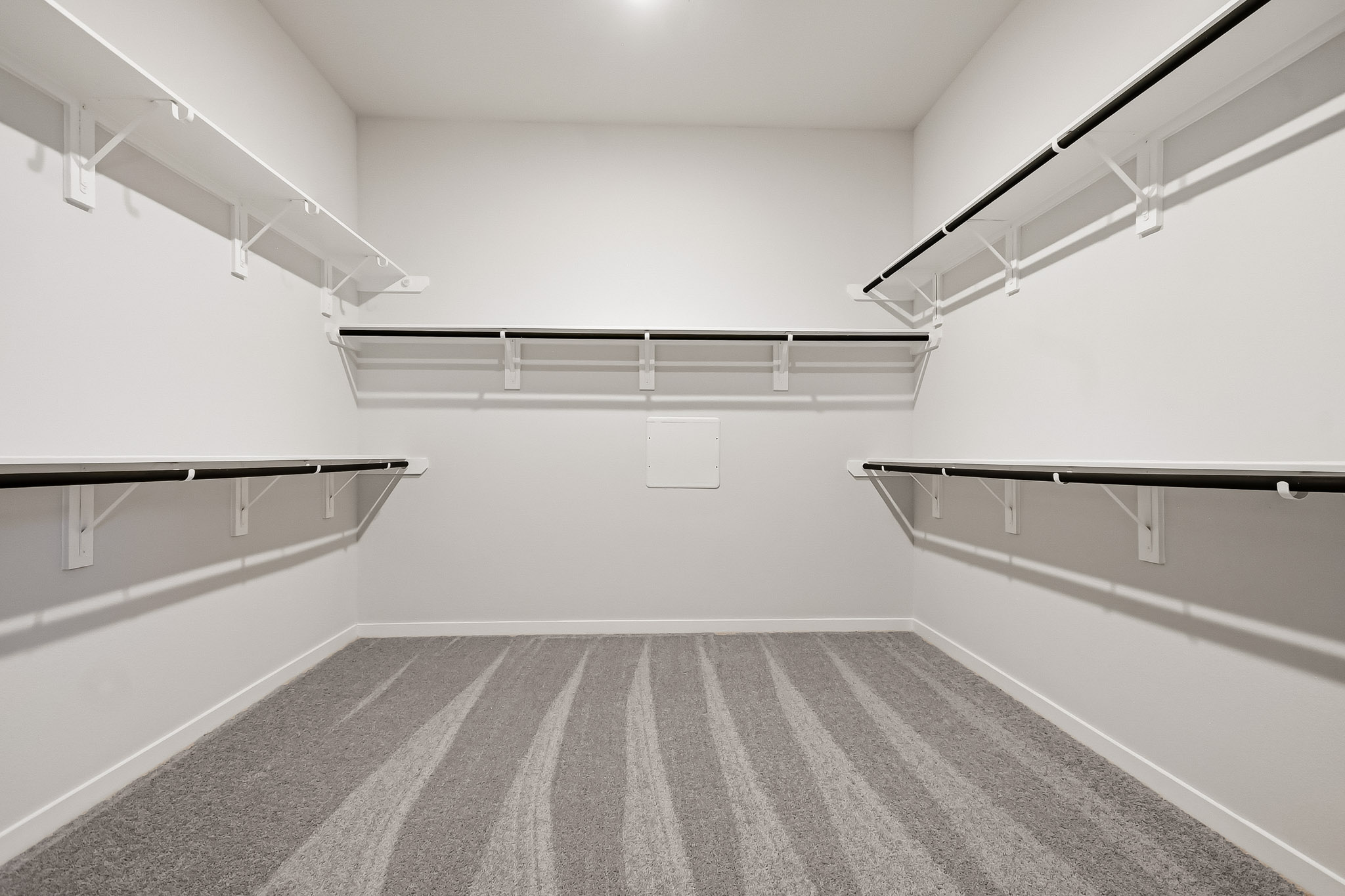 A white room with a carpet.