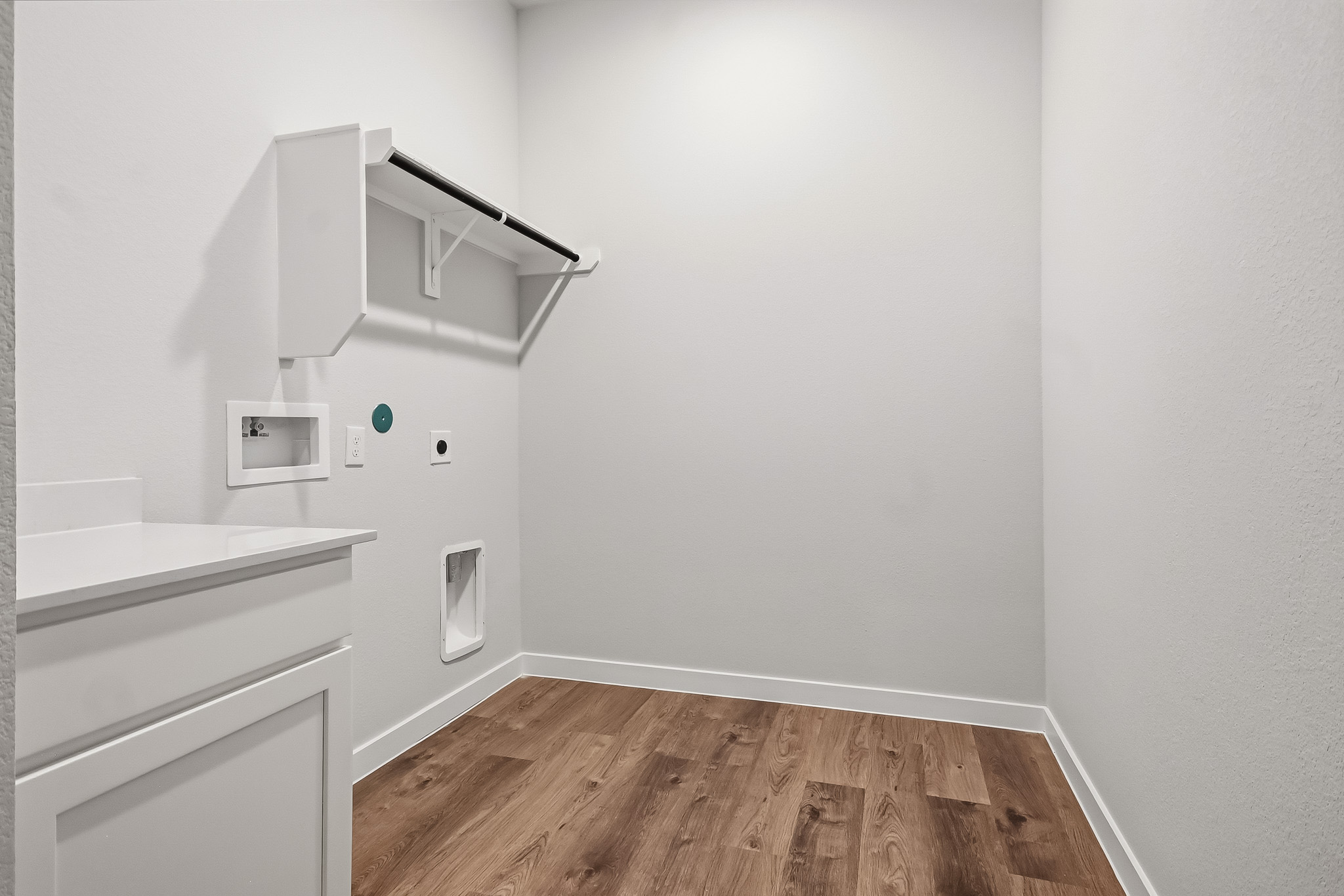 A room with a wood floor and white walls.