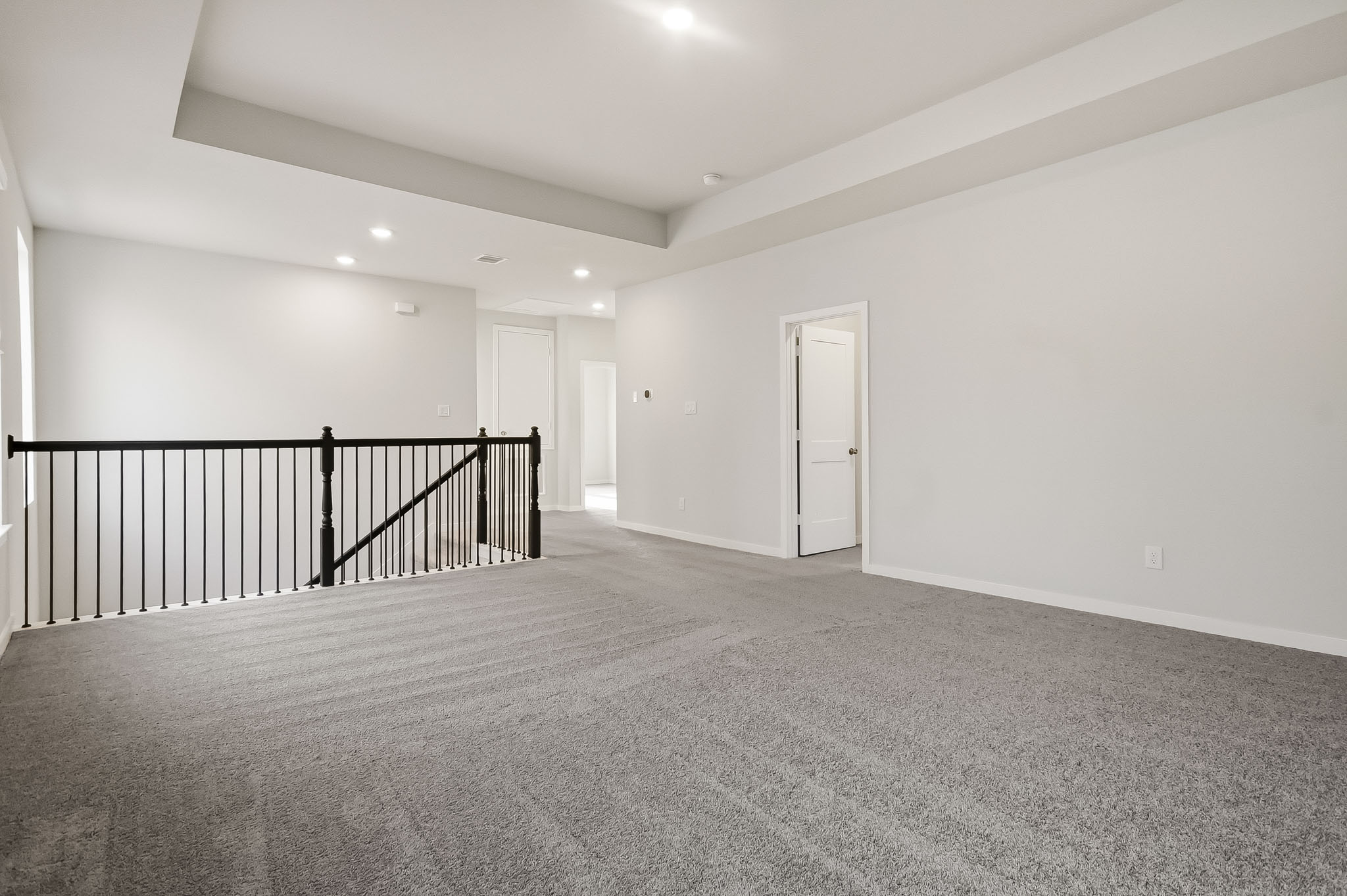 A hallway with a railing.