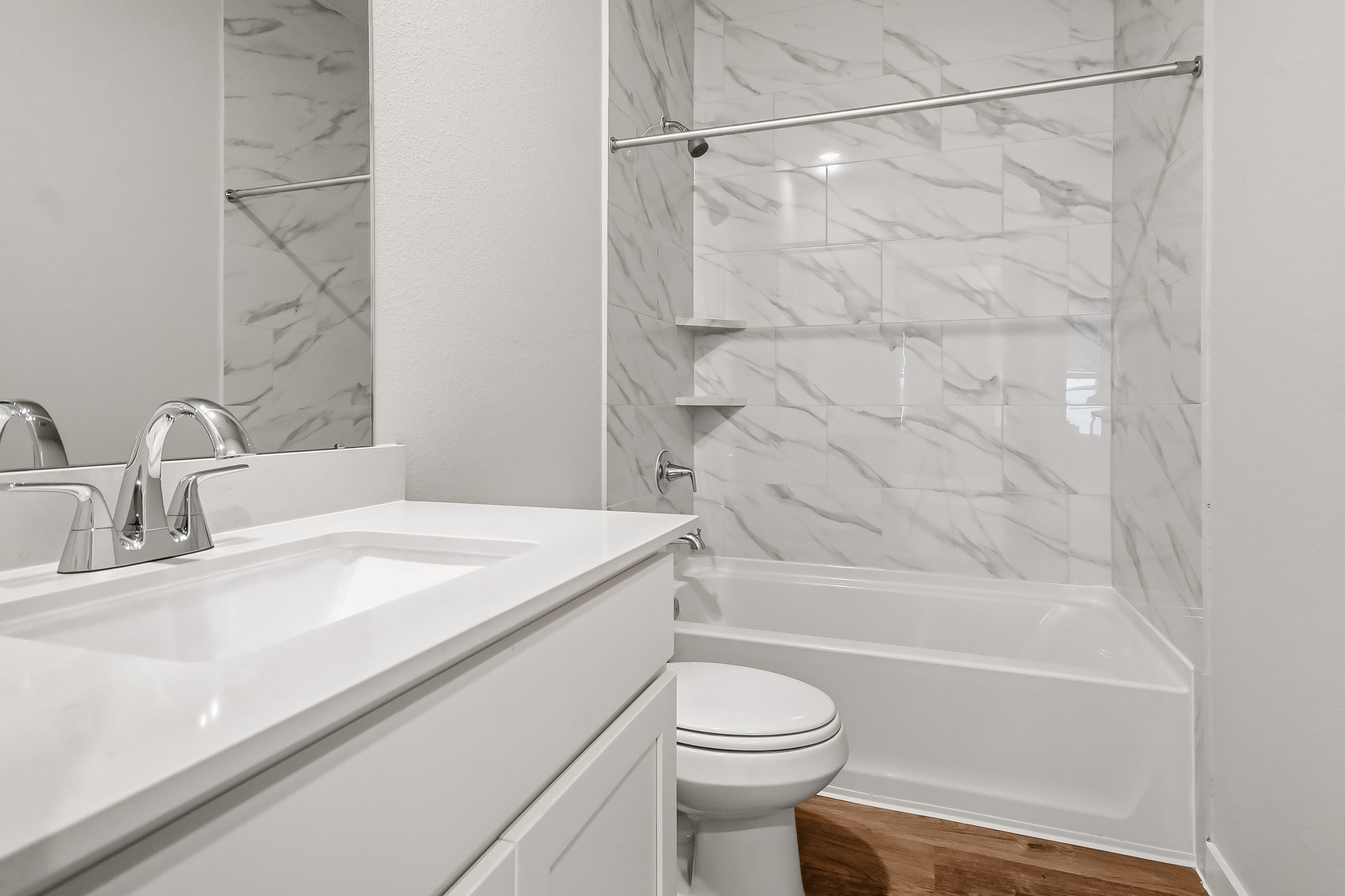A bathroom with a shower and sink.
