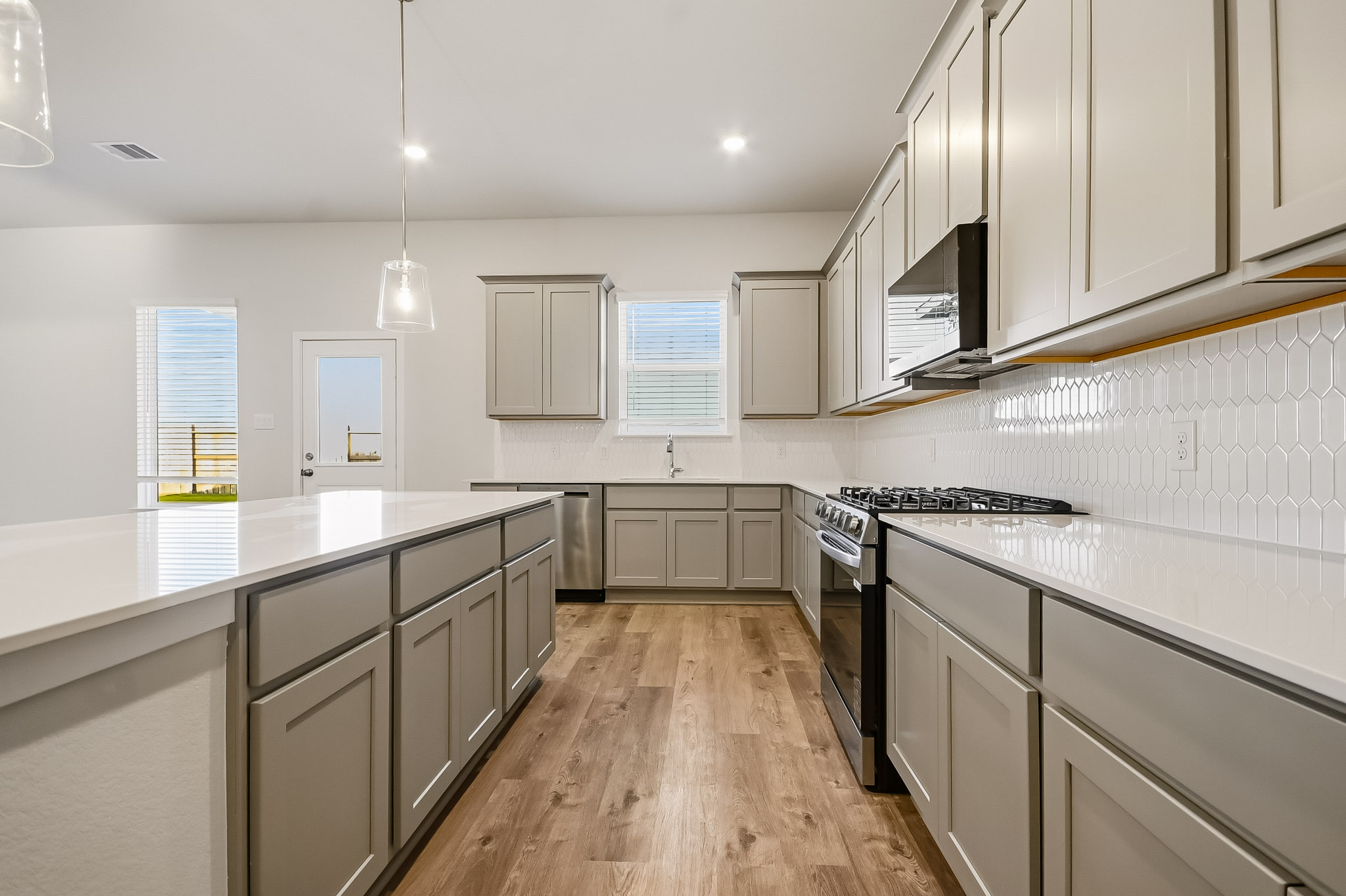 A kitchen with white cabinets.