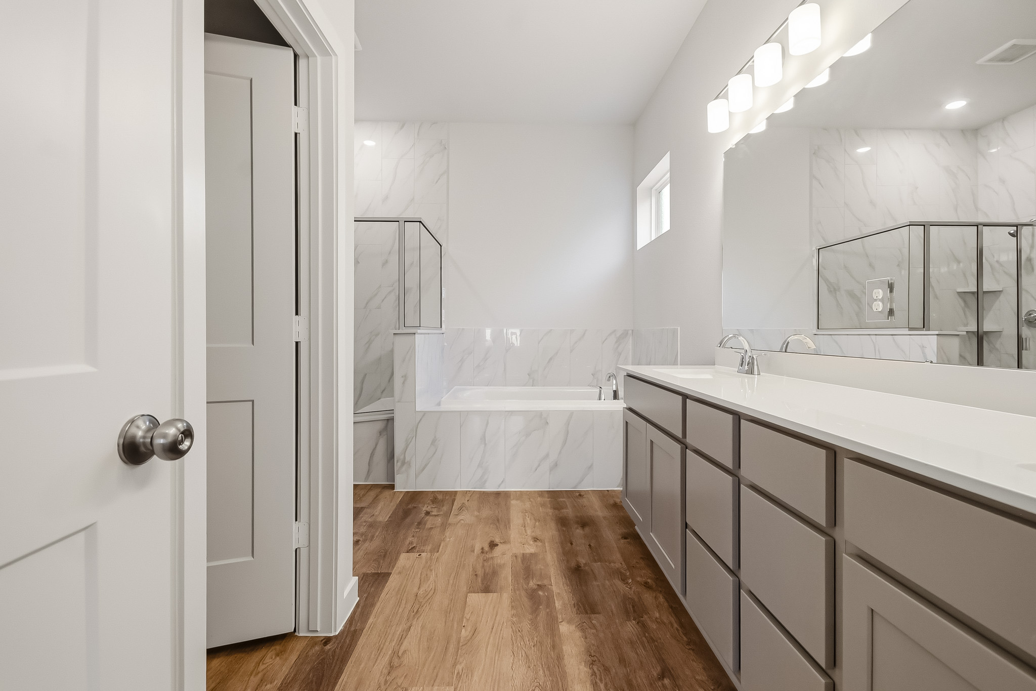 A bathroom with a tub and sink.