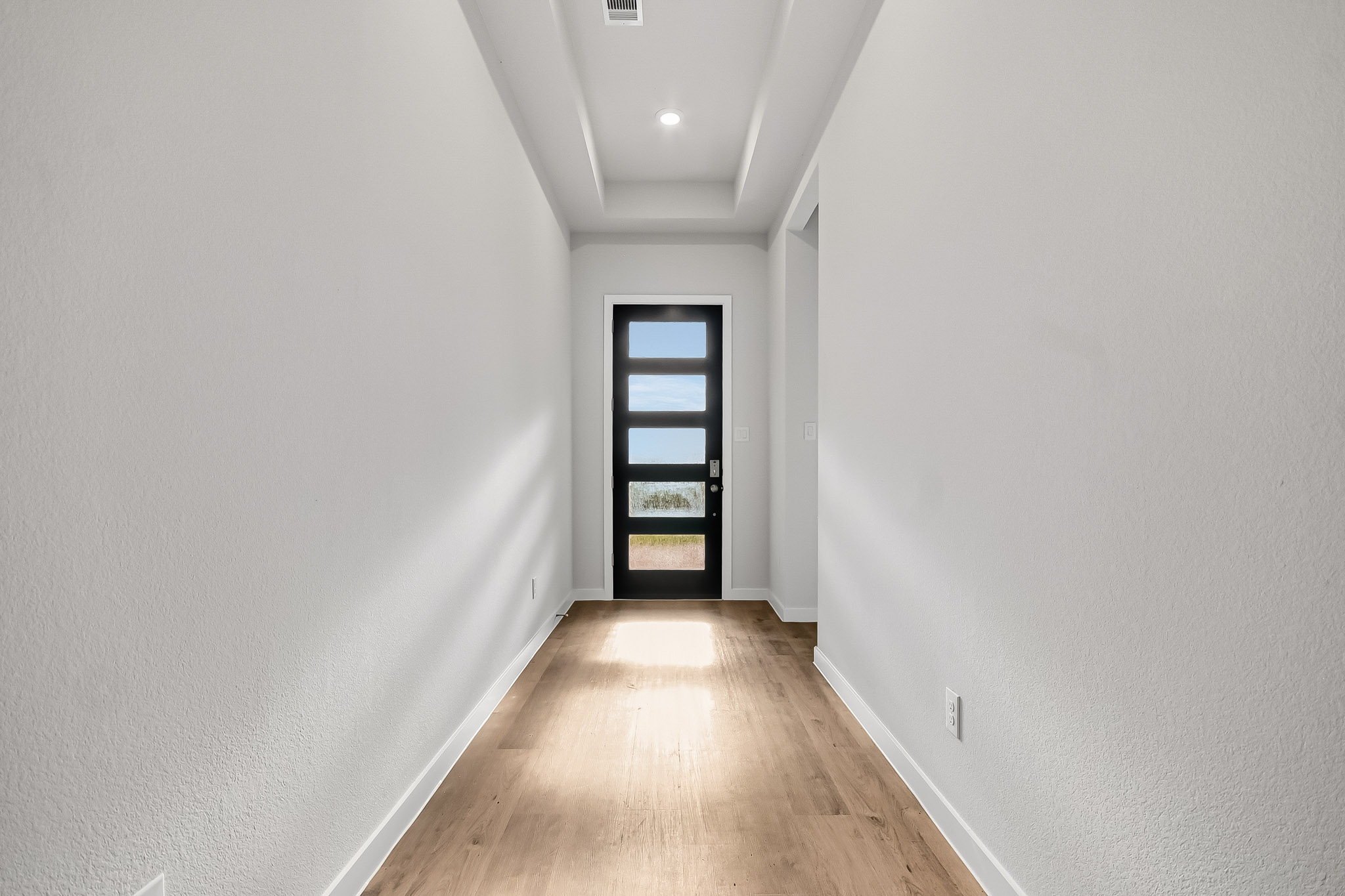A hallway with a door.