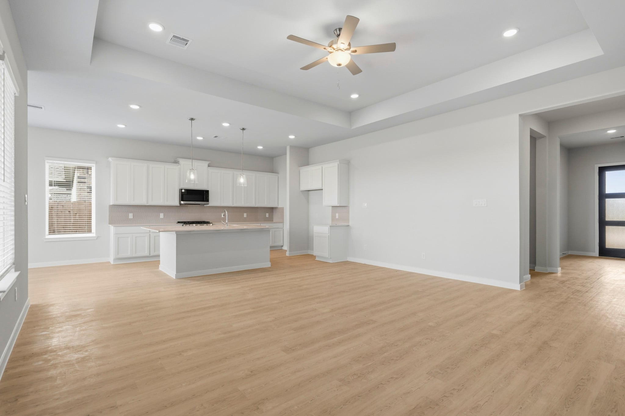 A large kitchen with white cabinets.