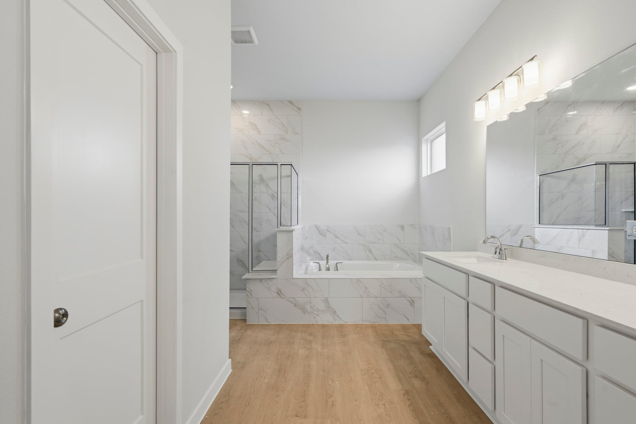 A bathroom with a tub and sink.