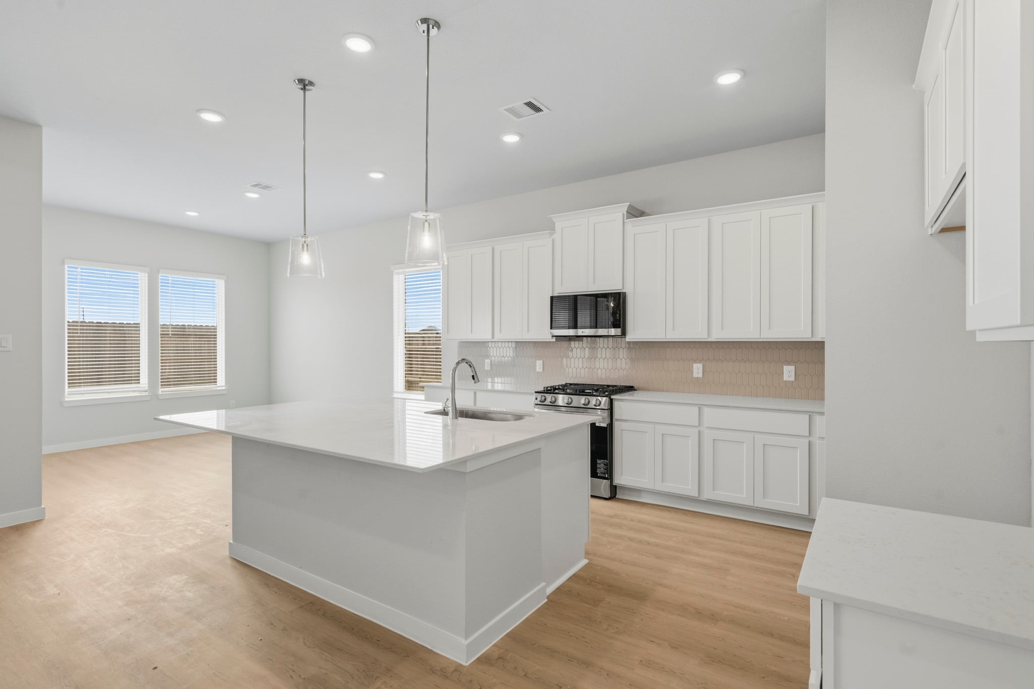 A kitchen with white cabinets.