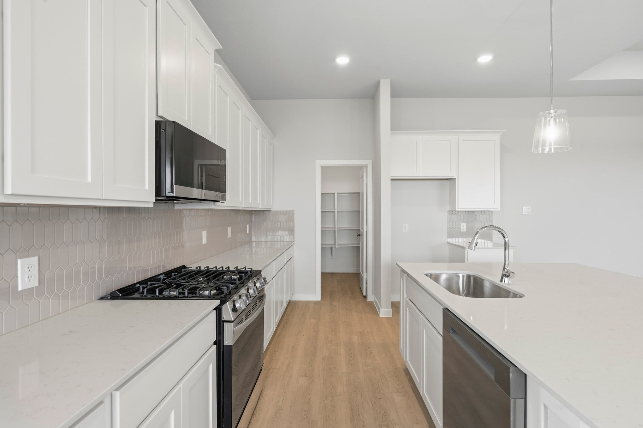 A kitchen with white cabinets.