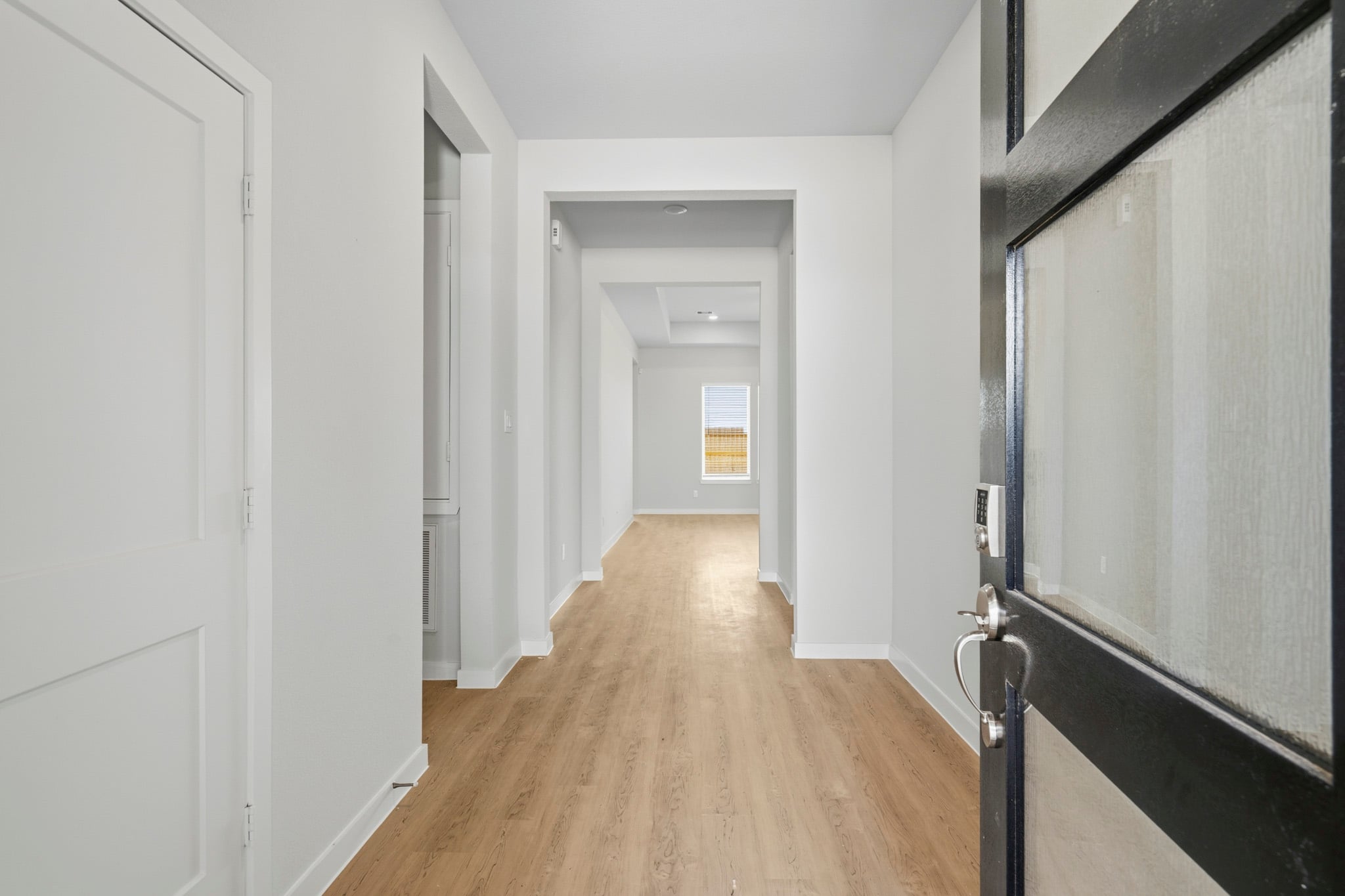 A hallway with white walls.