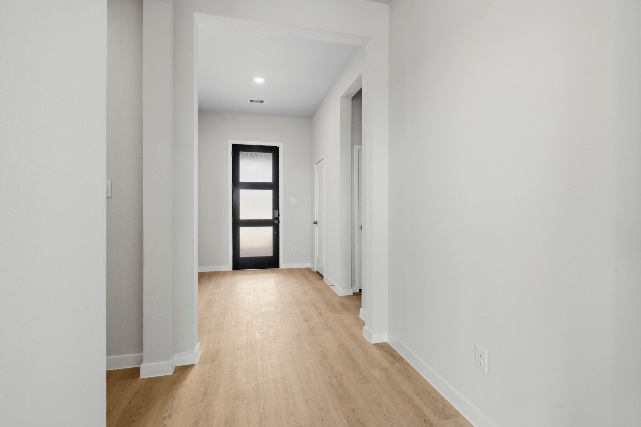 A hallway with white walls.