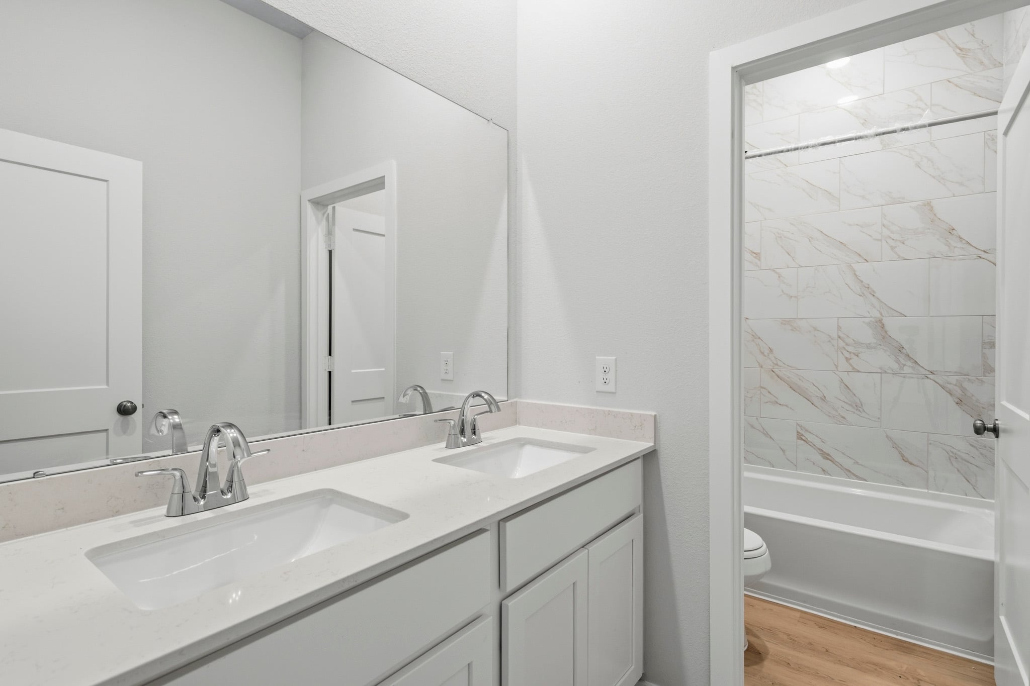A bathroom with a shower and sink.