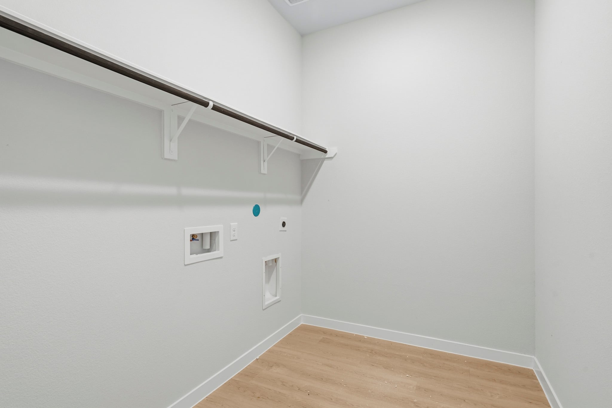 A white room with a wood floor.