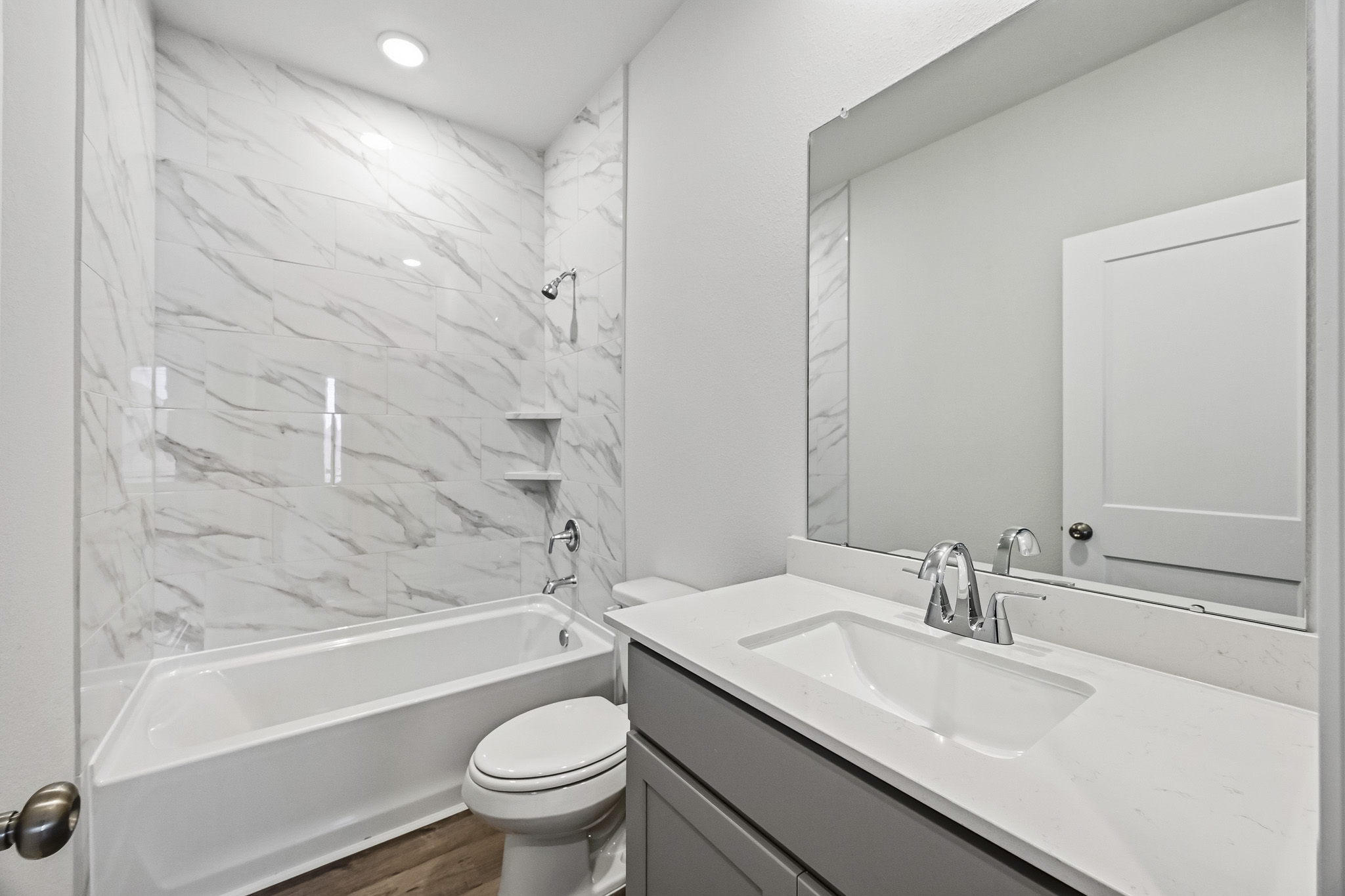 A bathroom with a tub sink and toilet.