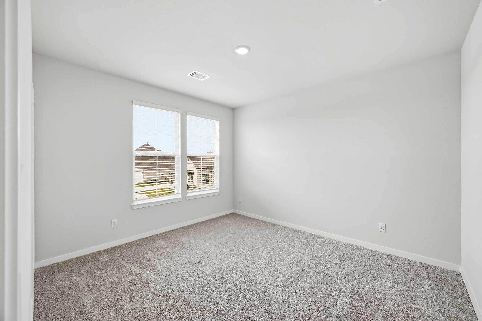 A room with a window and a carpet.