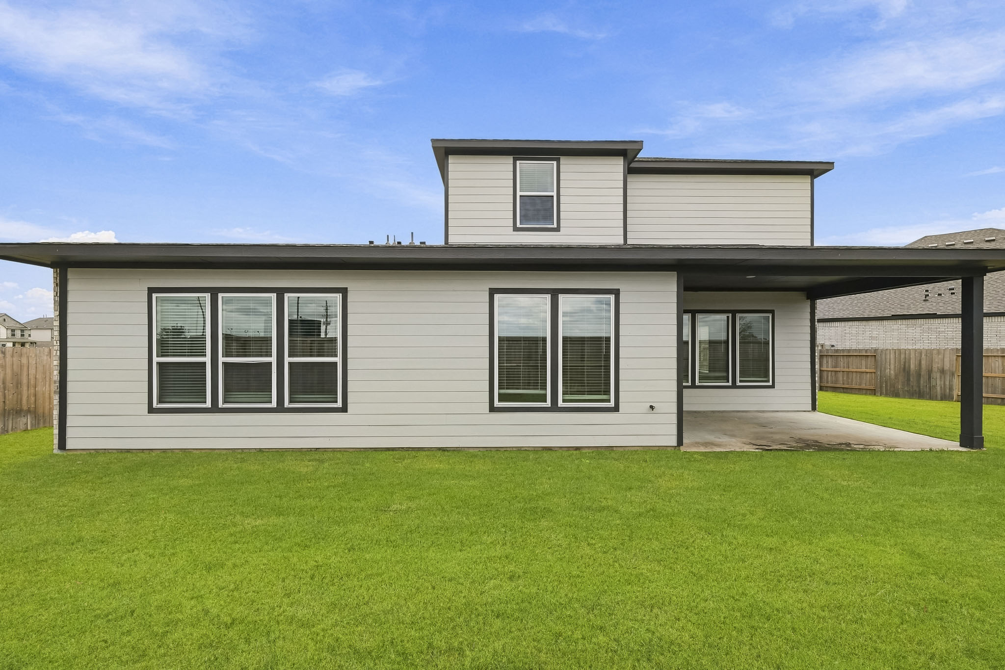 A house with a fence and grass.