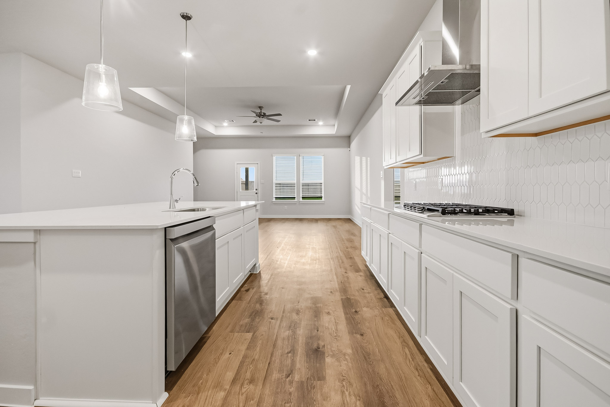 A kitchen with white cabinets.