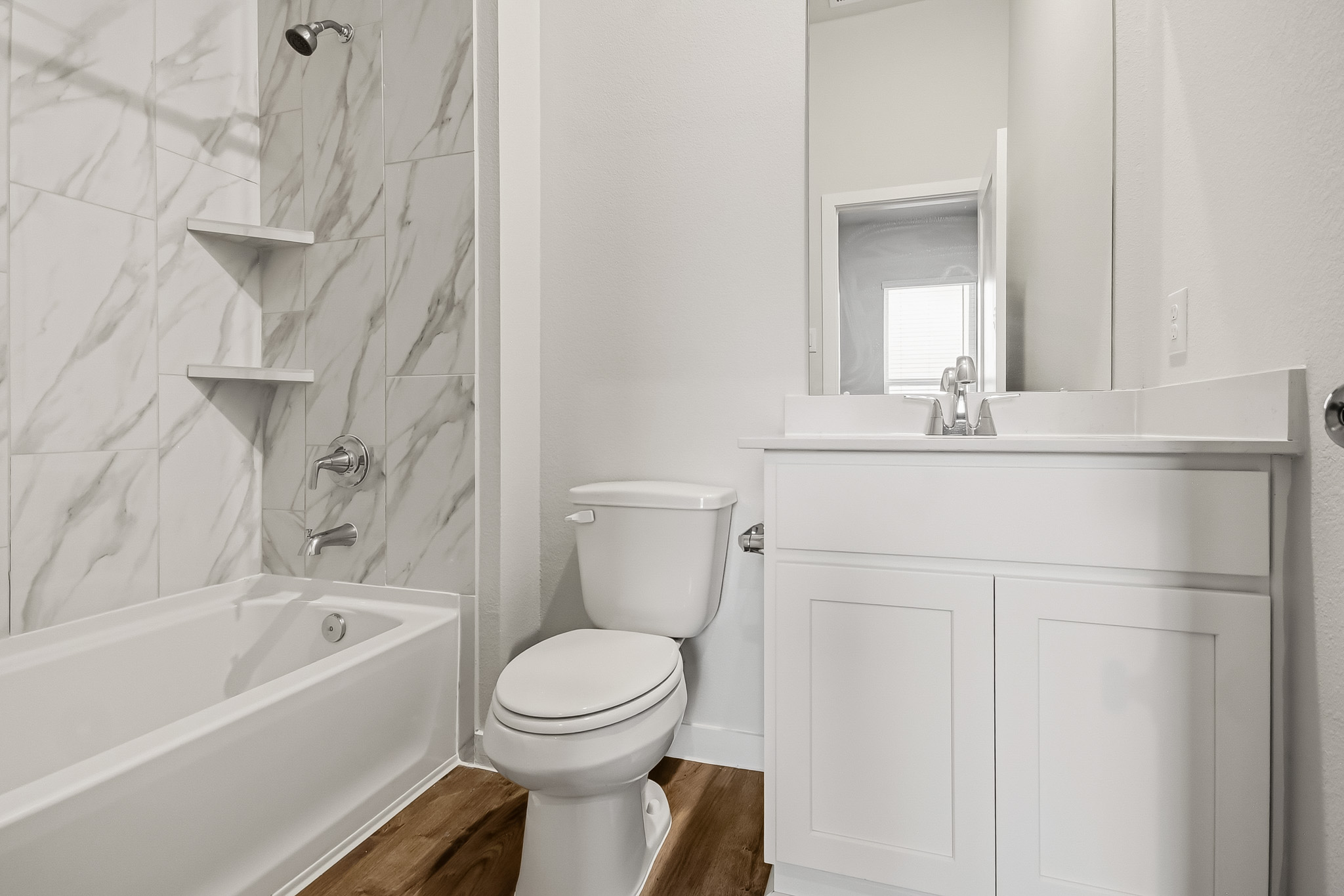 A bathroom with a toilet and bathtub.