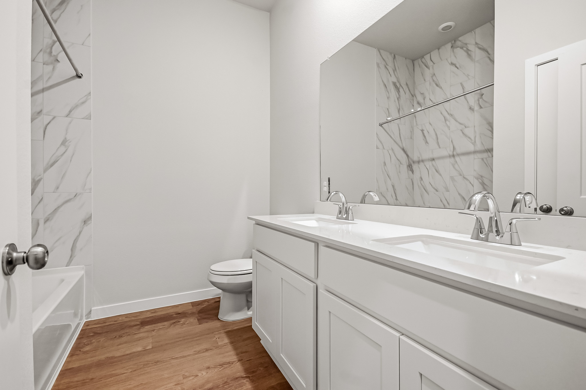 A bathroom with a tub sink and toilet.
