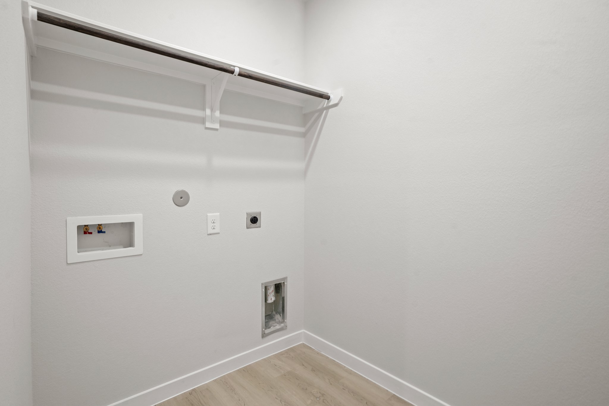 A white wall with a light fixture.