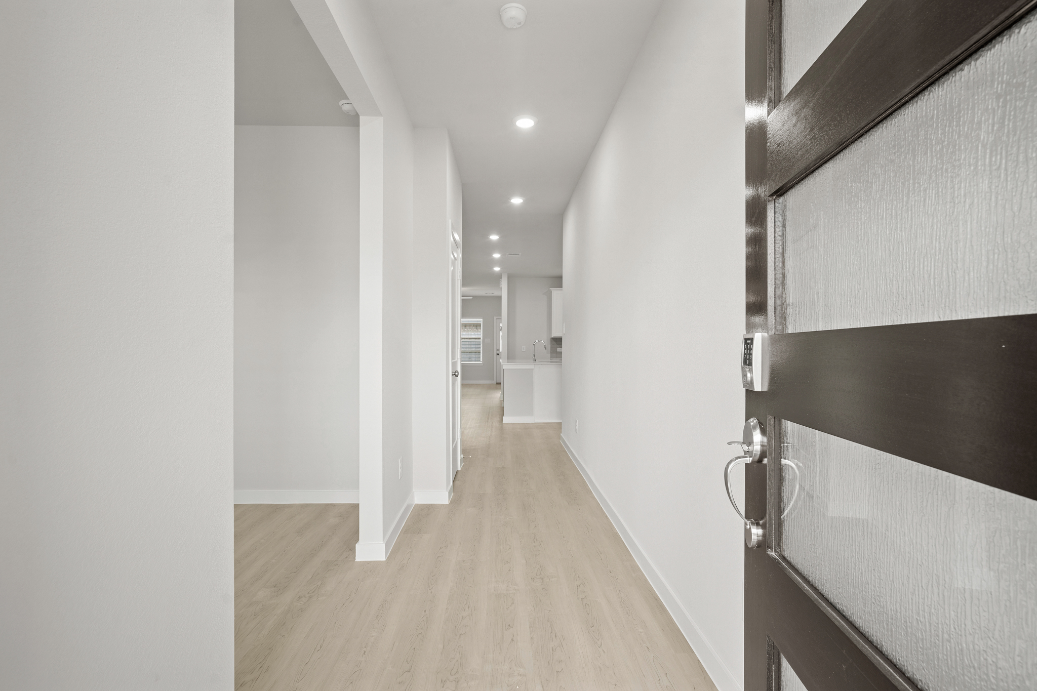 A hallway with white walls.