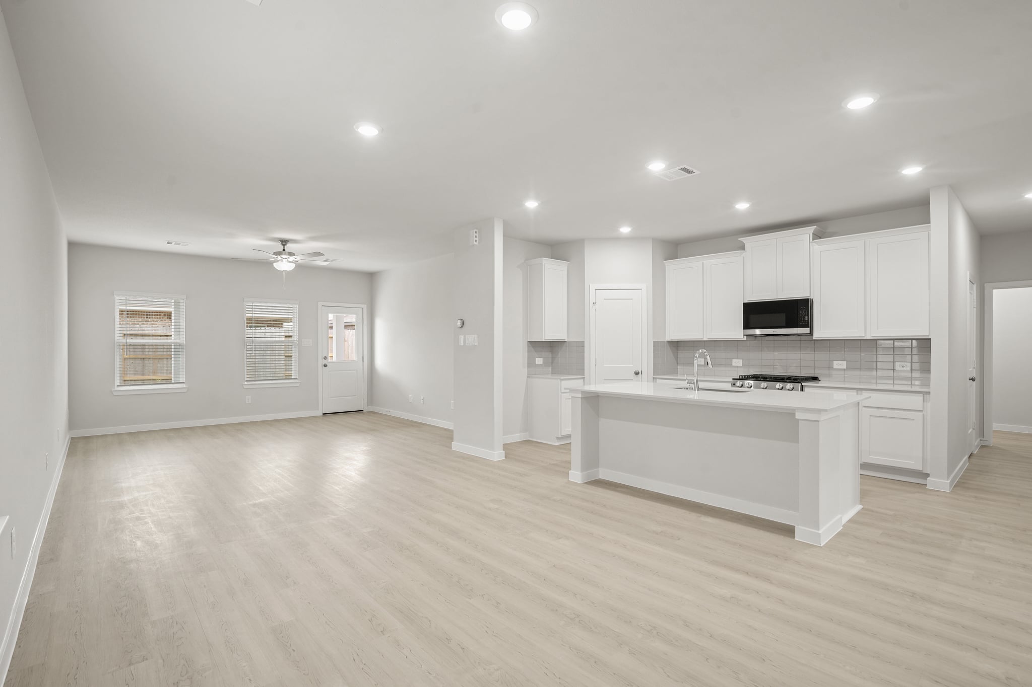 A large kitchen with white cabinets.