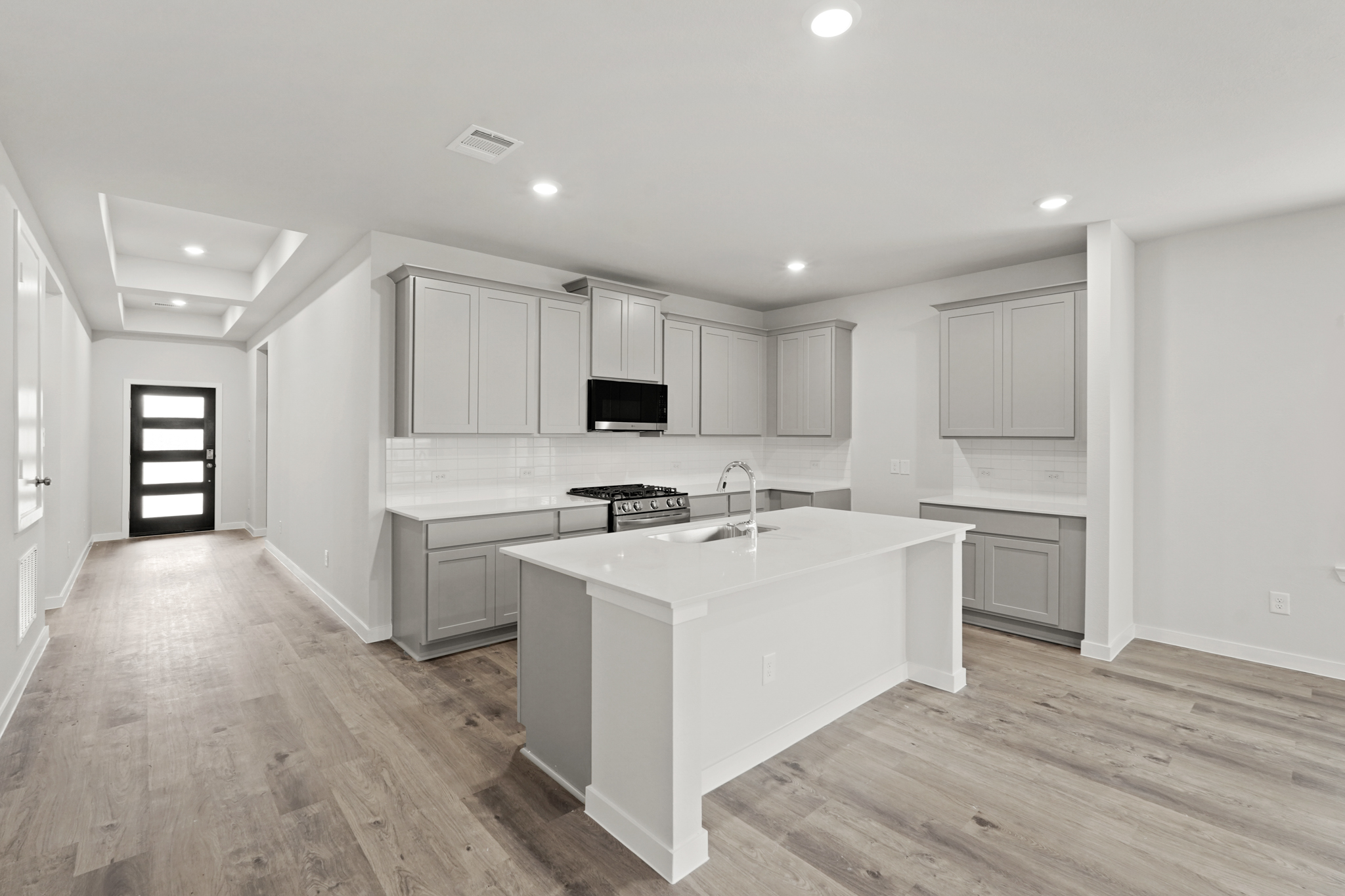 A kitchen with white cabinets.