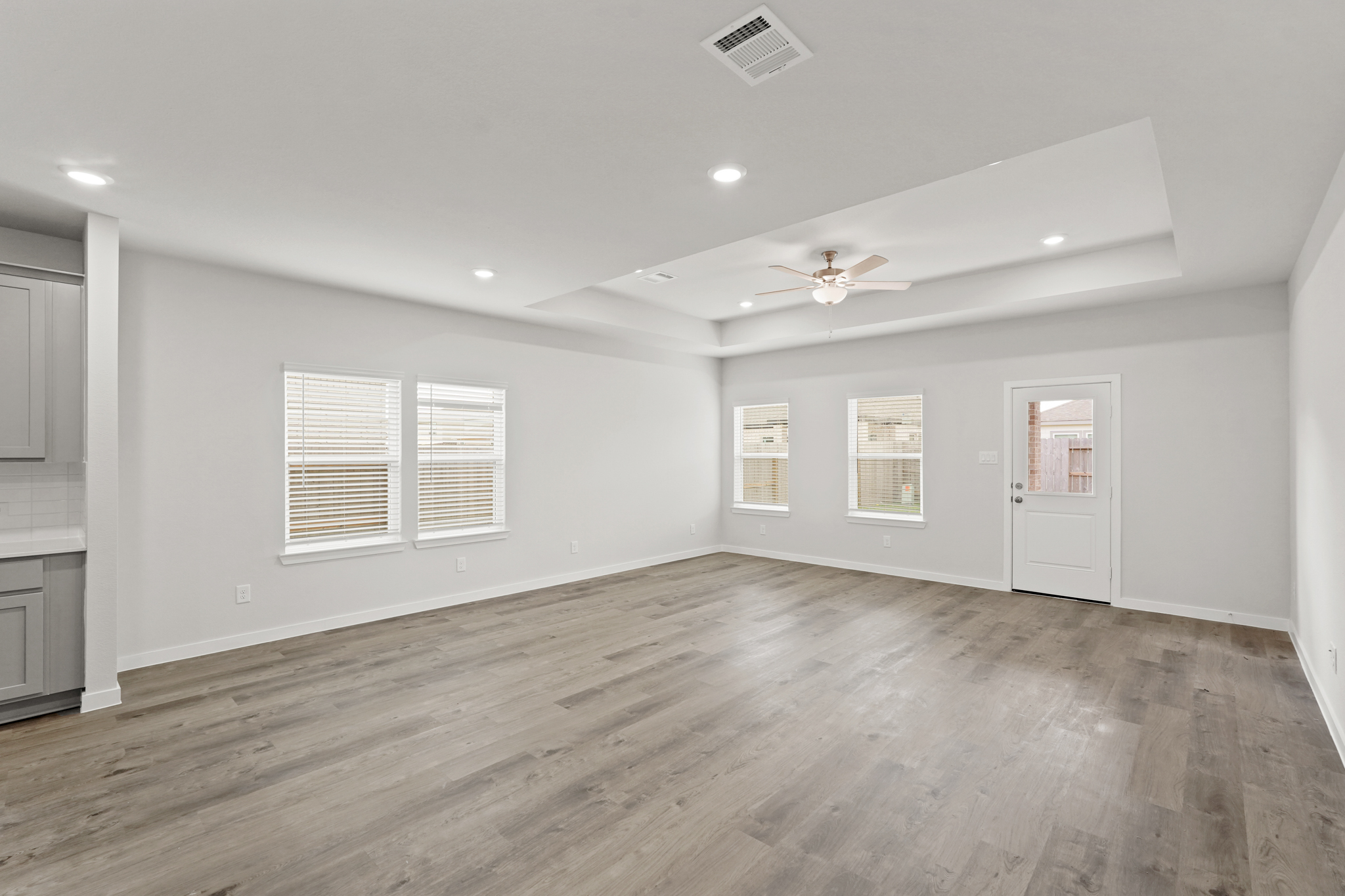 A room with a wood floor and white walls.