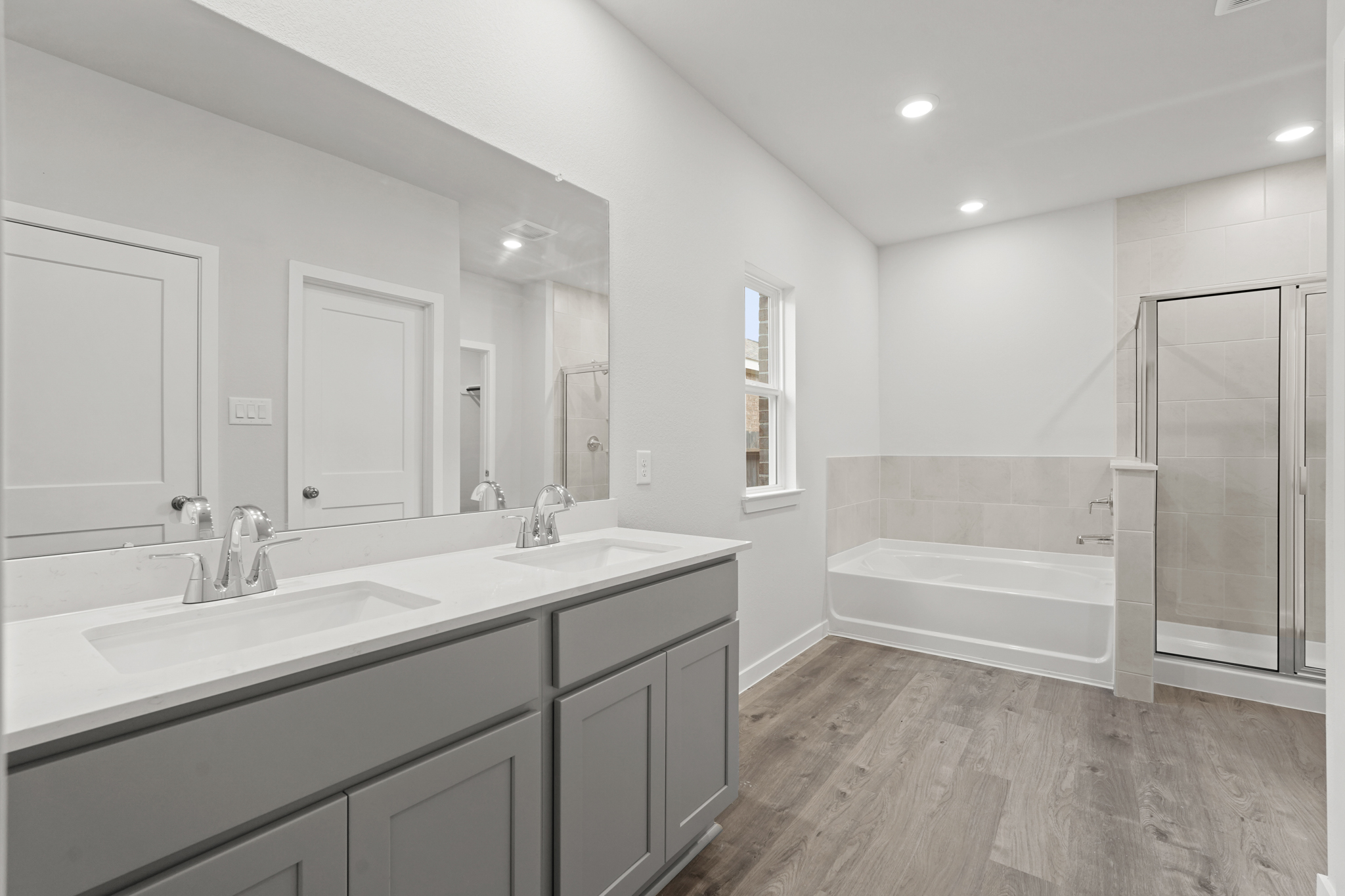 A bathroom with a tub sink and a shower.