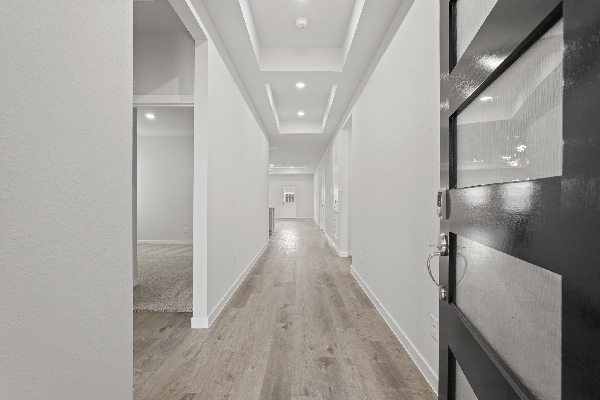 A hallway with white walls.