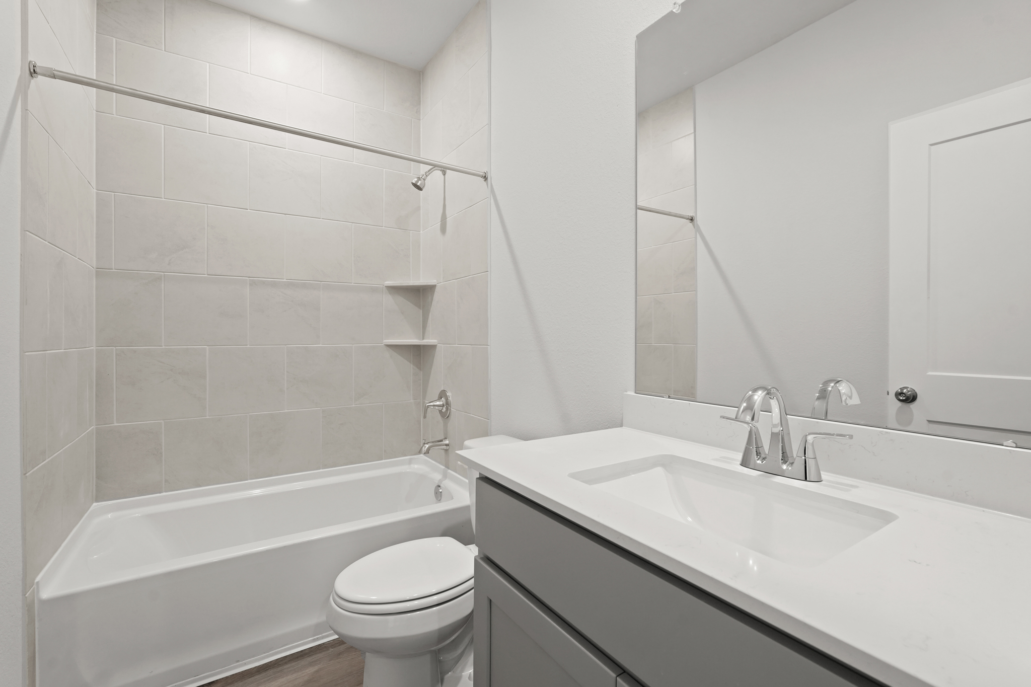 A bathroom with a tub sink and toilet.