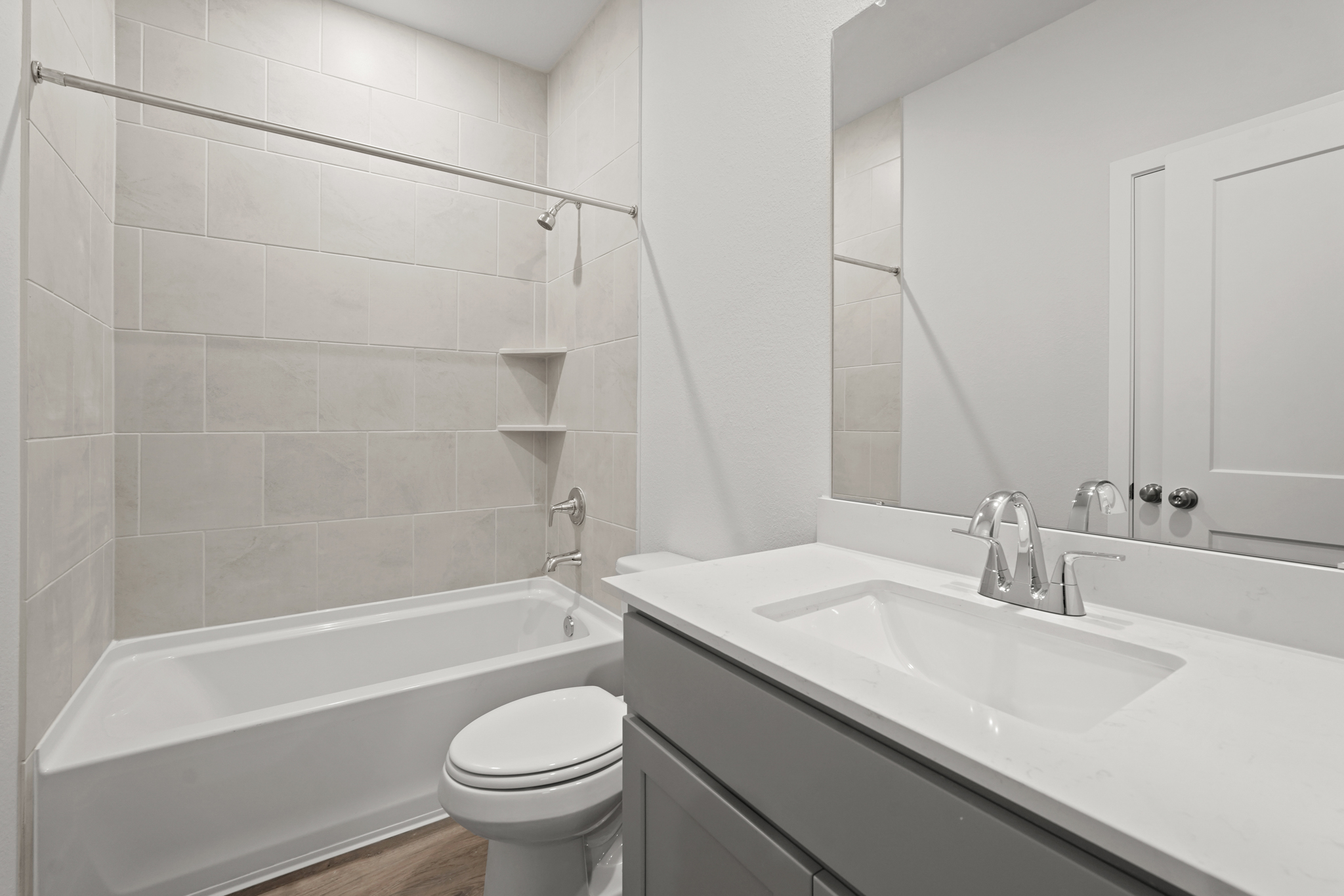 A bathroom with a tub sink and toilet.