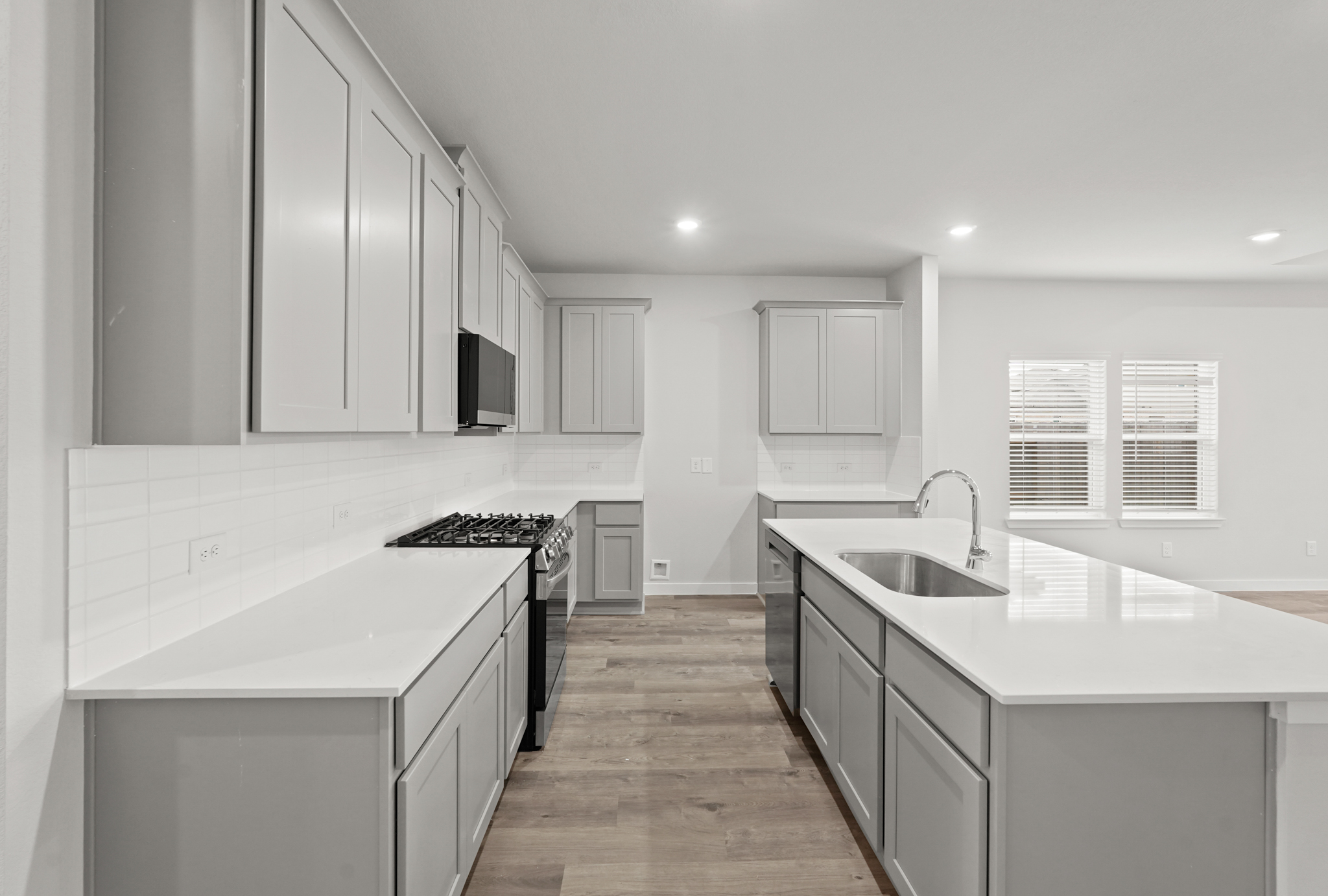 A kitchen with white cabinets.