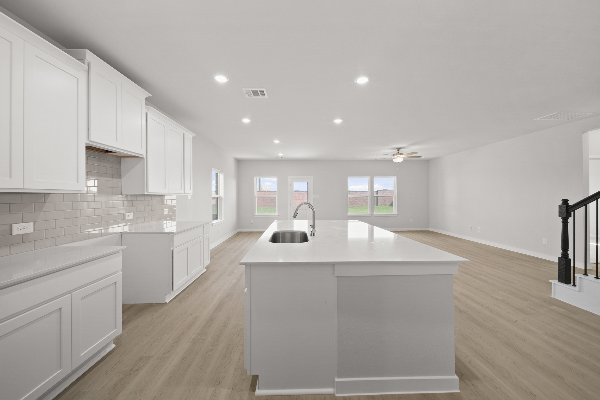 A kitchen with white cabinets.