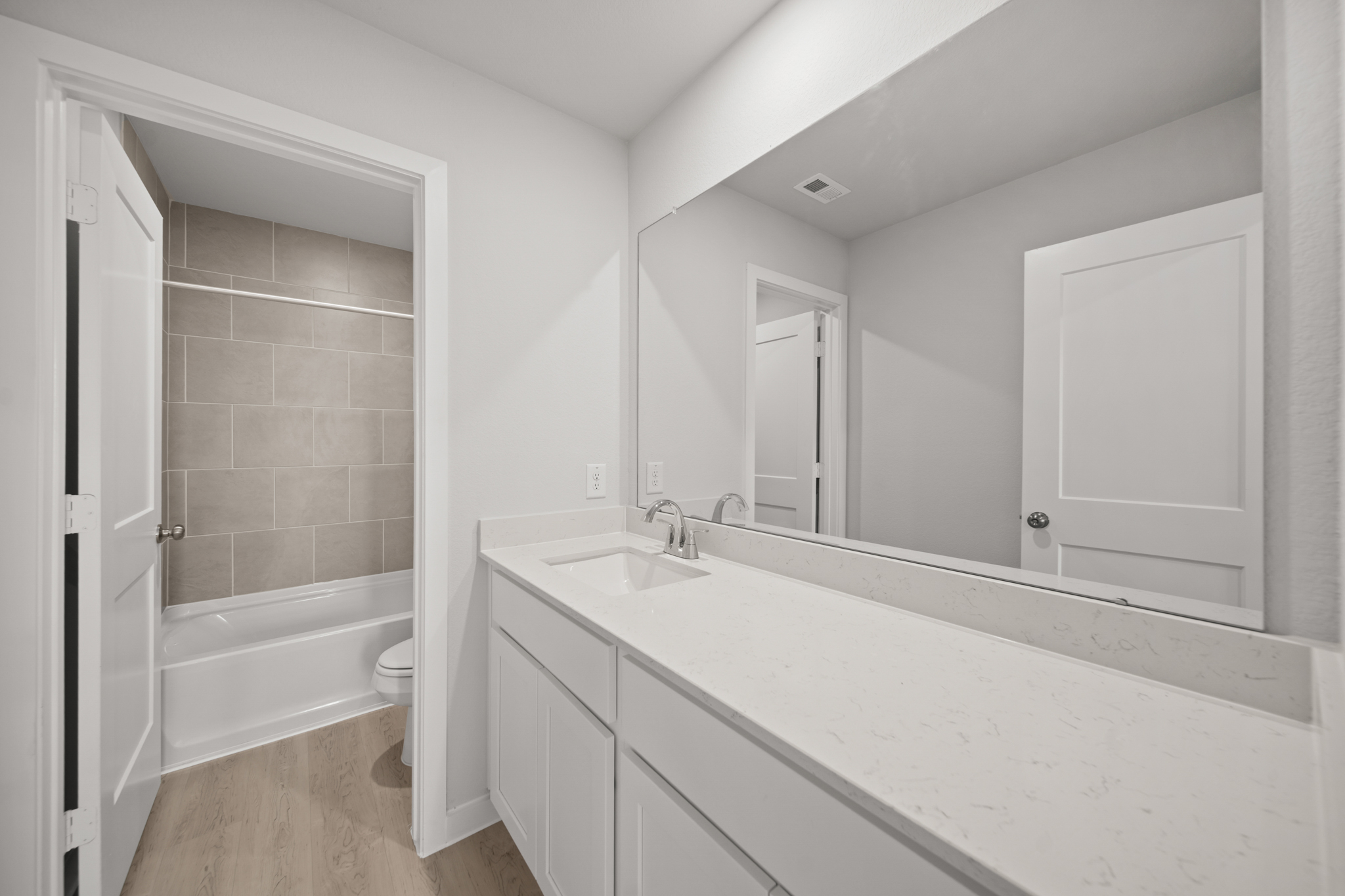 A bathroom with a tub sink and toilet.
