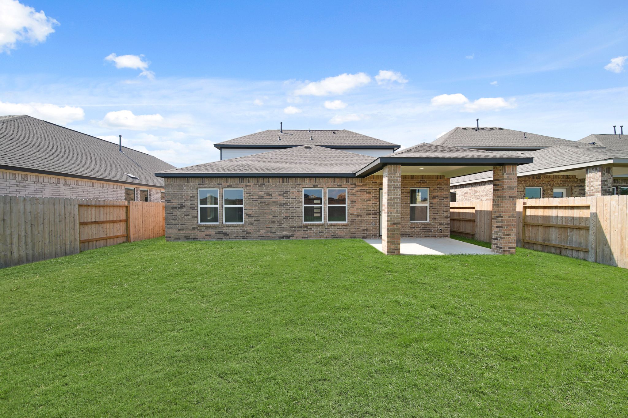 A large house with a green lawn.