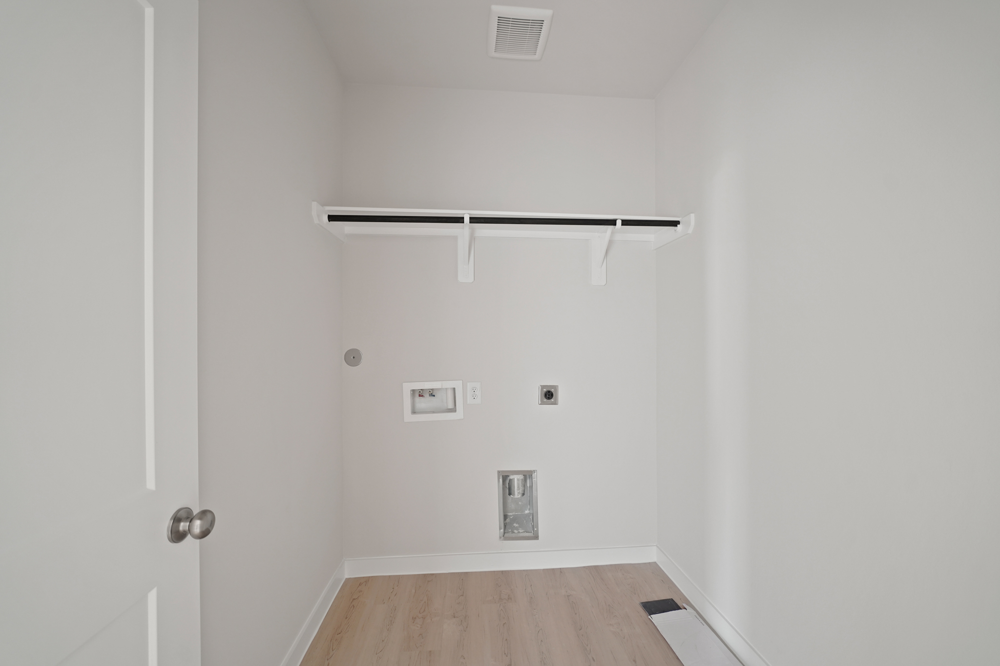 A room with a wood floor and white walls.