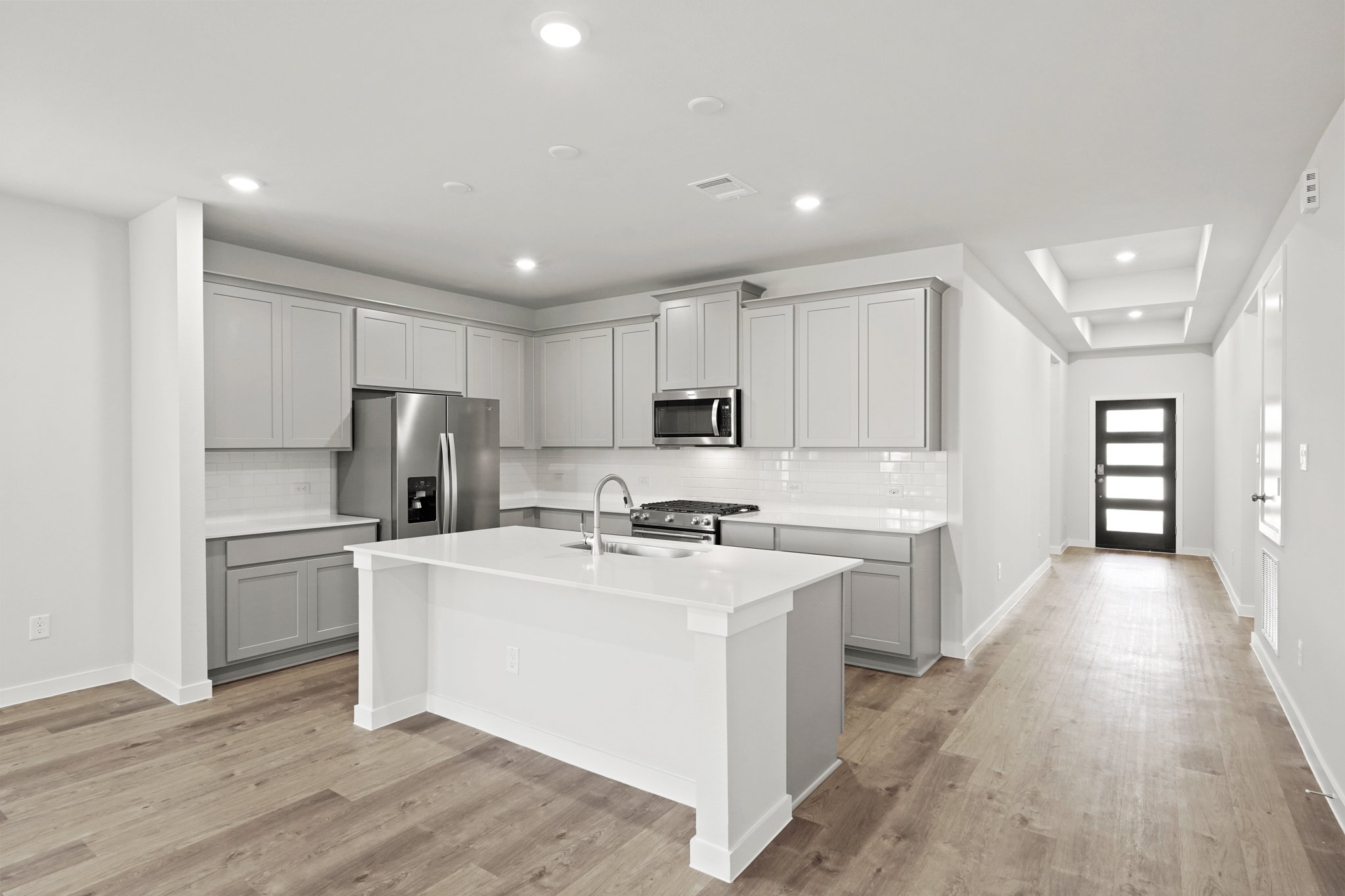 A kitchen with white cabinets.