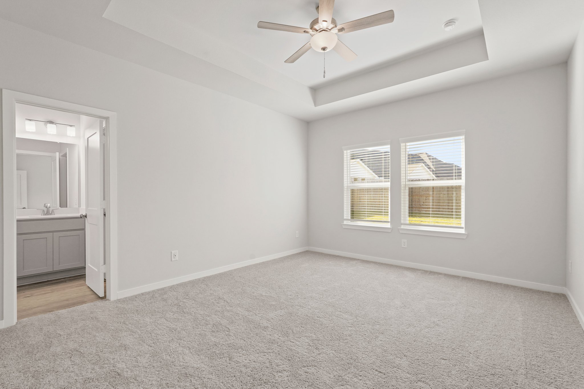 A room with a ceiling fan and a window.