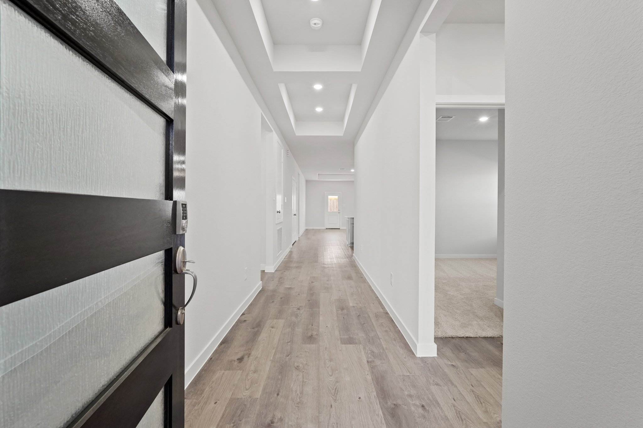 A hallway with white walls.