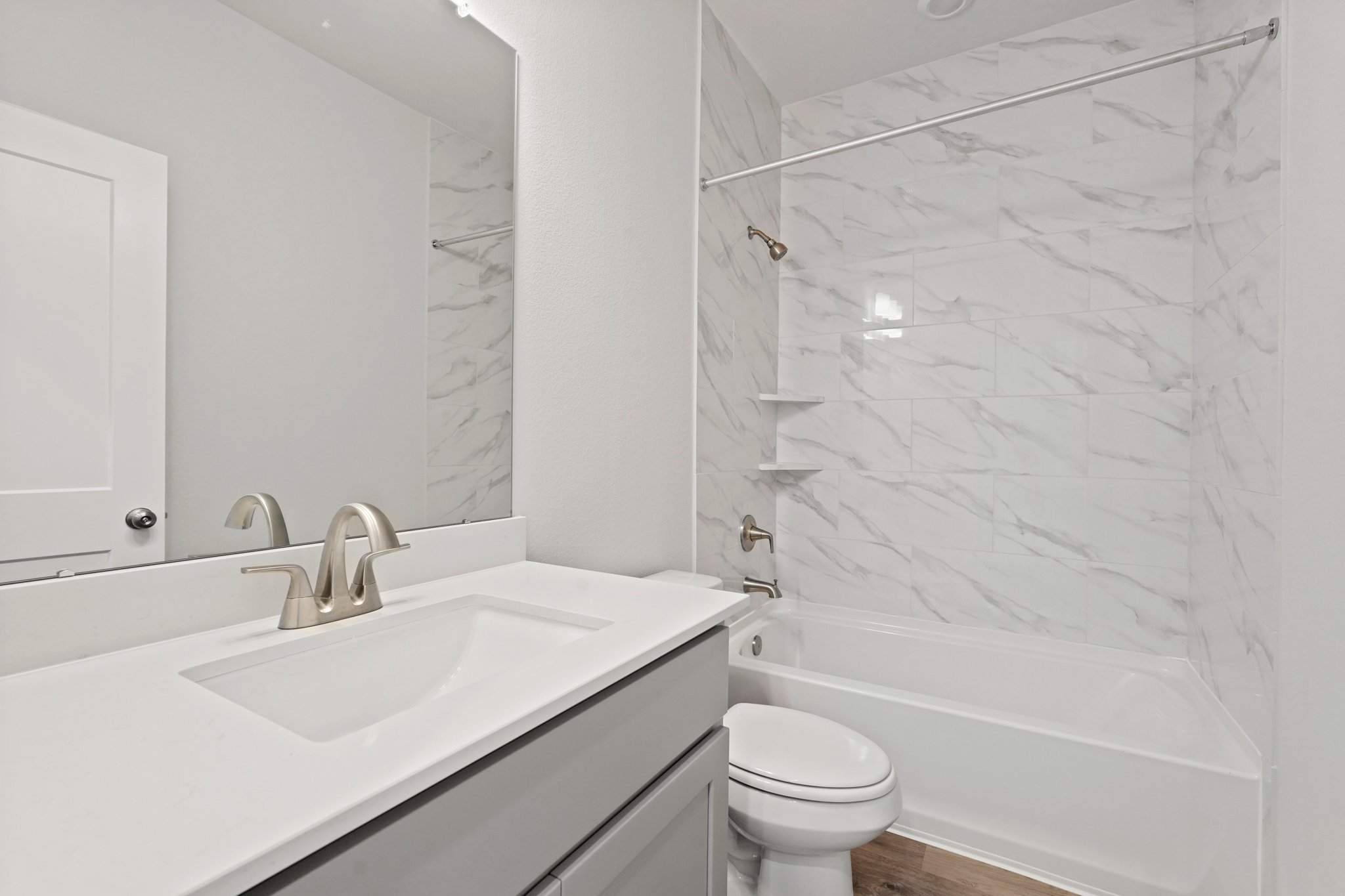 A bathroom with a sink and a toilet.