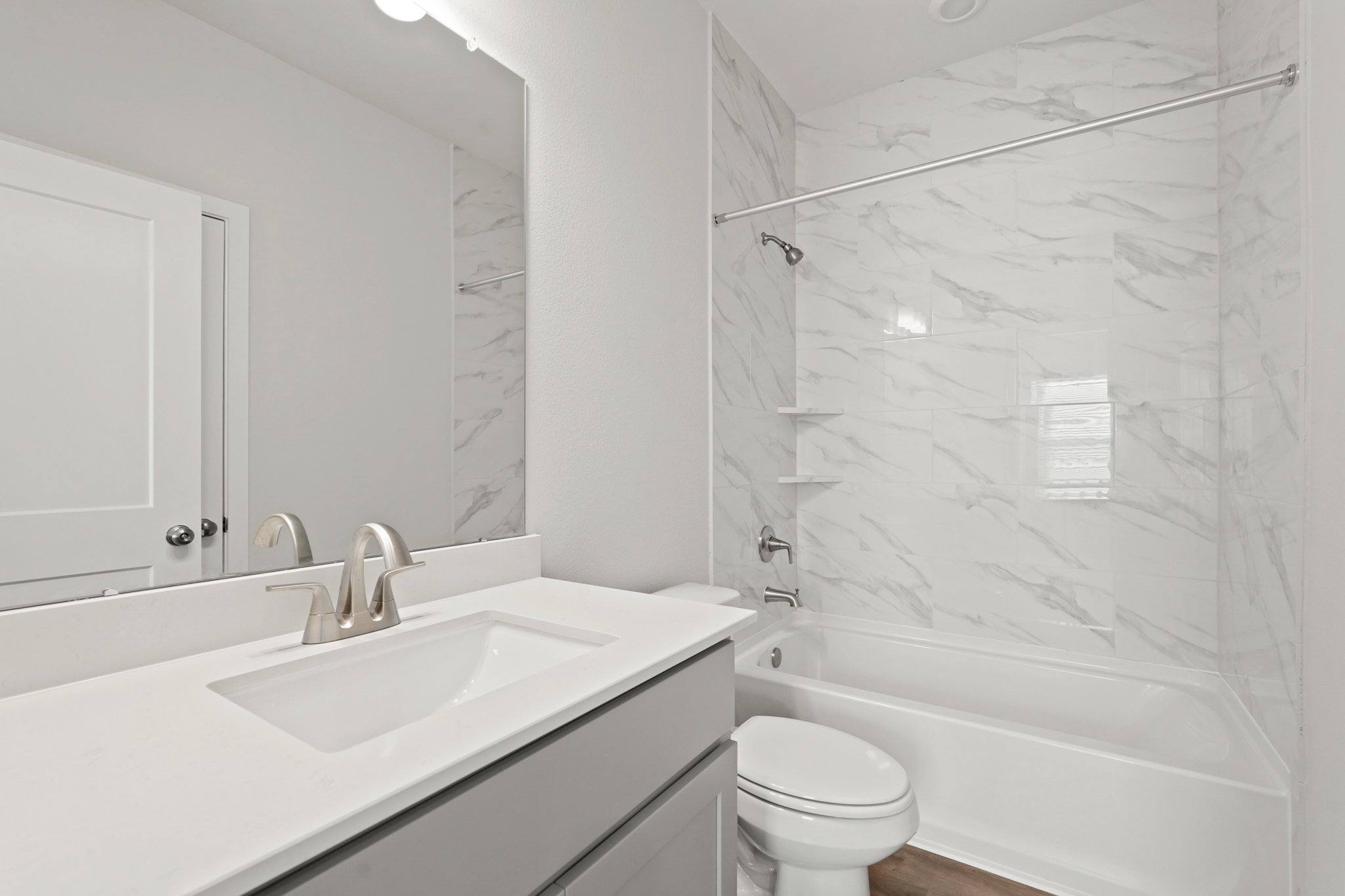 A bathroom with a tub sink and toilet.
