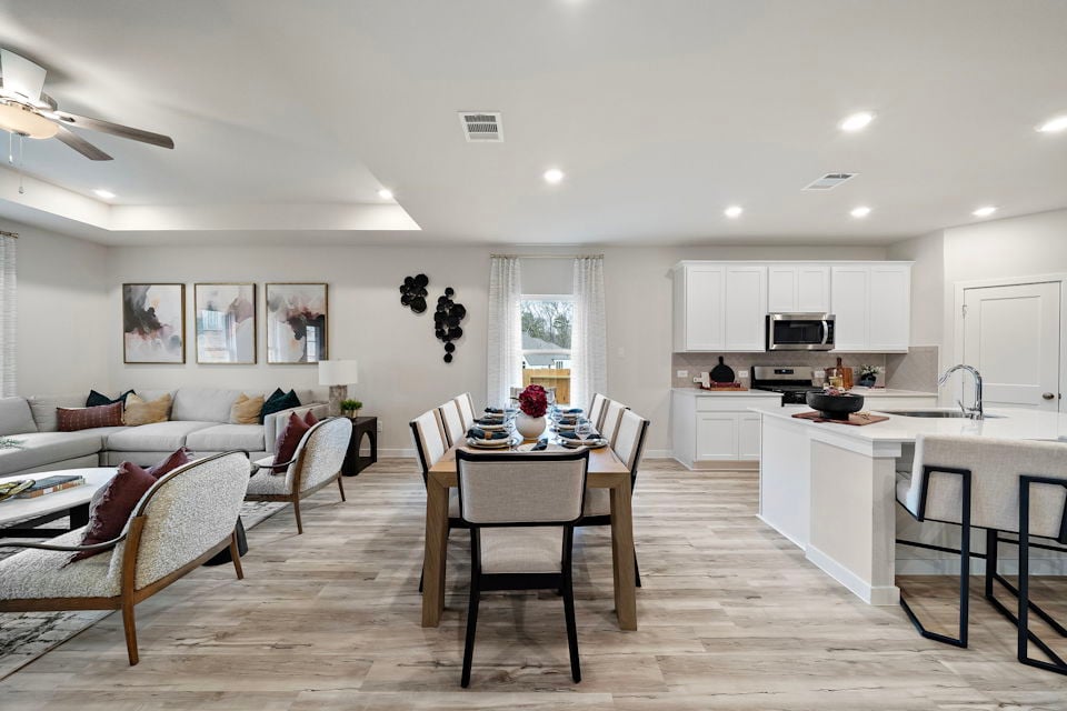 A large kitchen with a dining table.