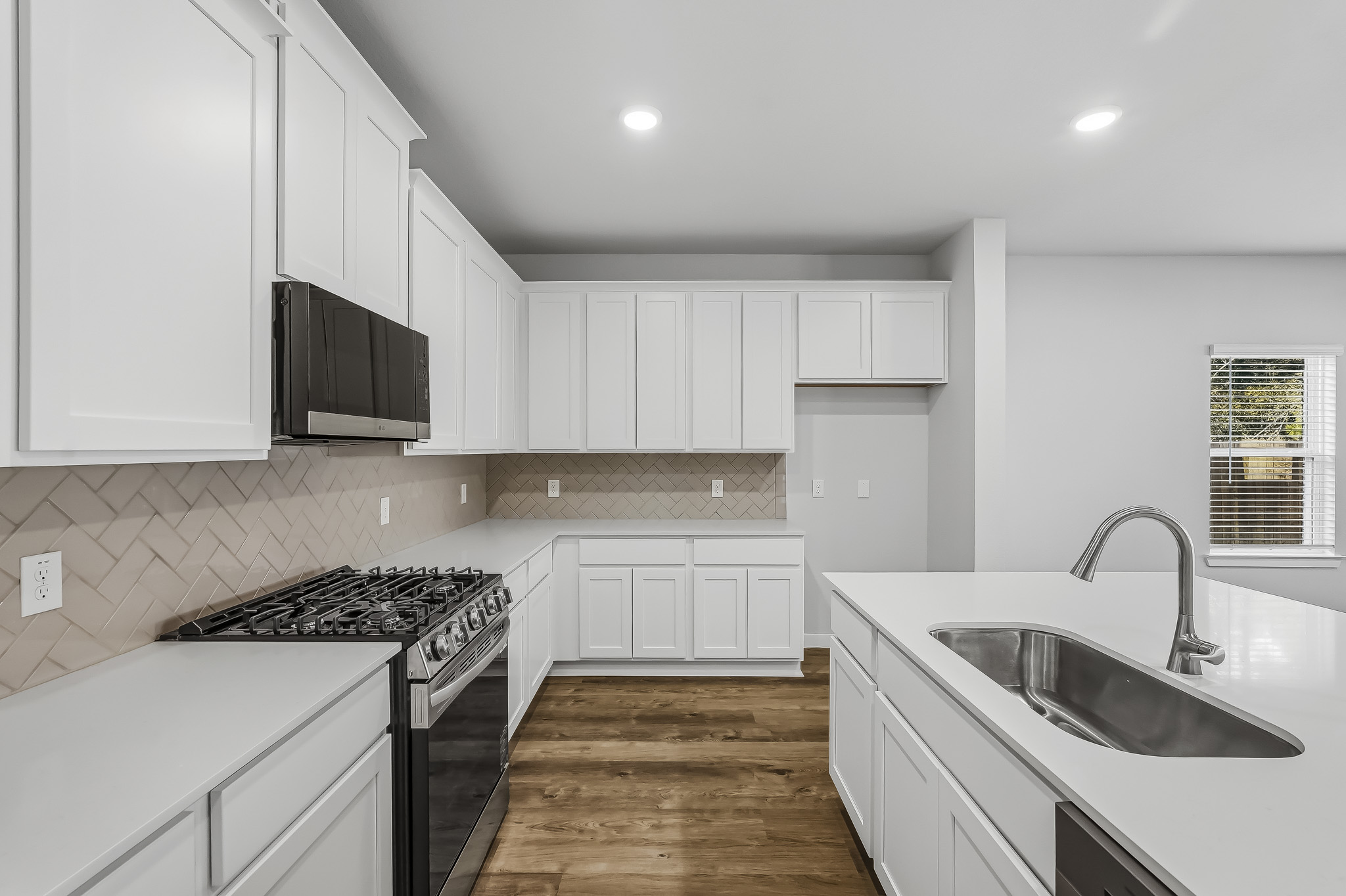 A kitchen with white cabinets.
