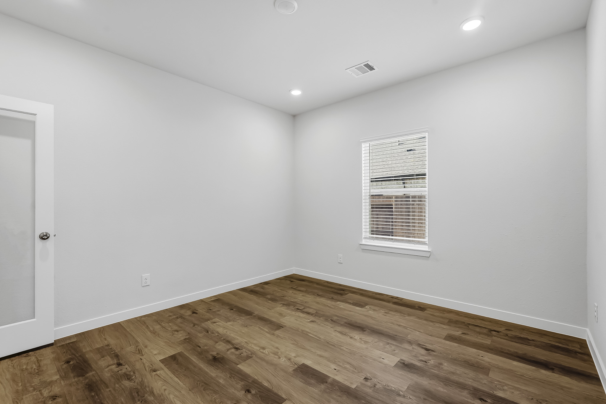 A room with a wood floor and a wood floor.