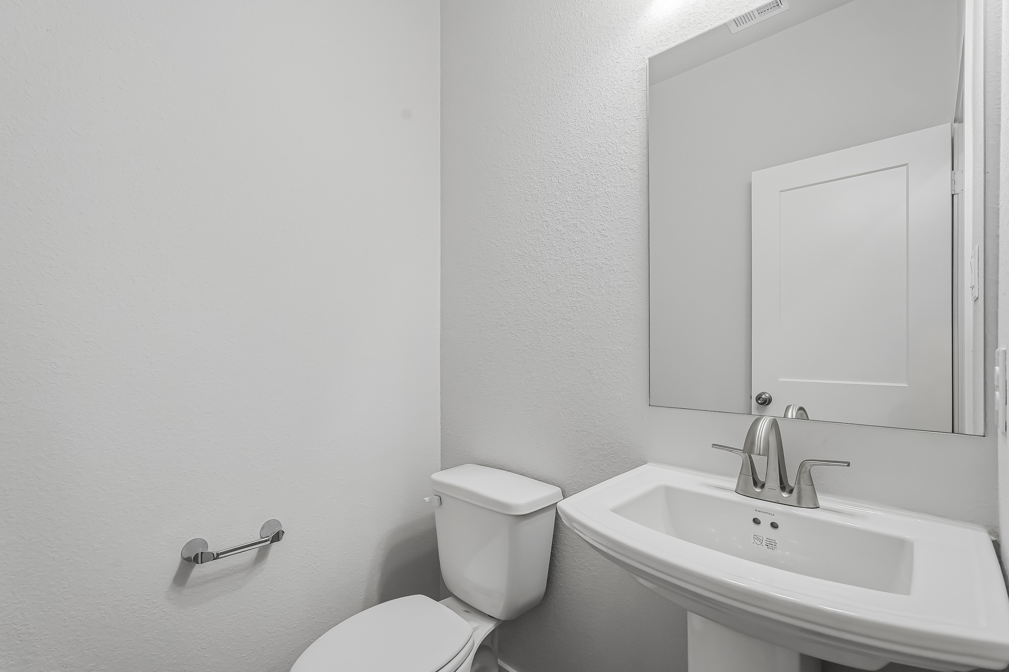 A bathroom with a toilet and sink.