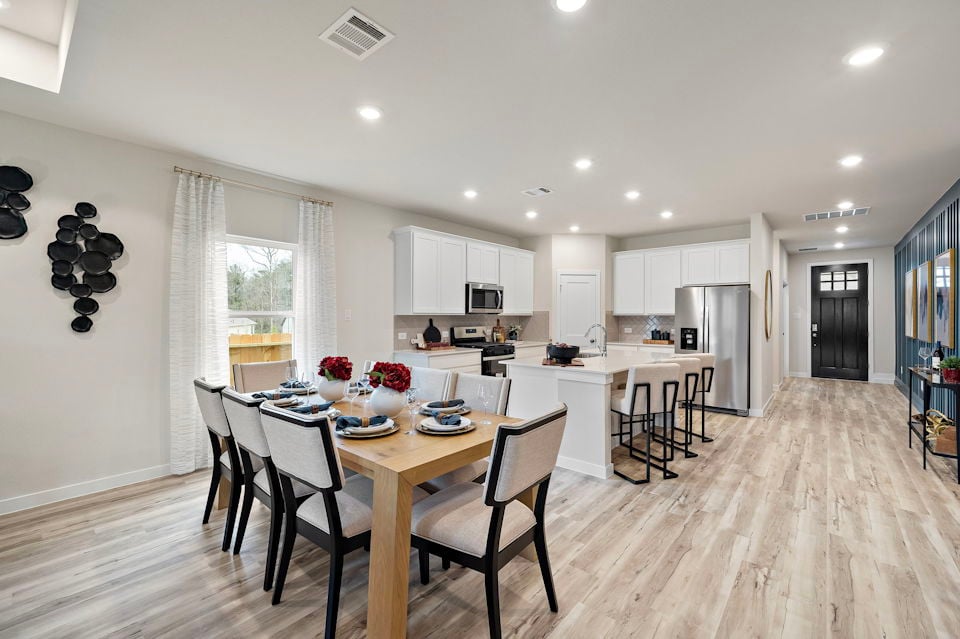 A large kitchen with a dining table.